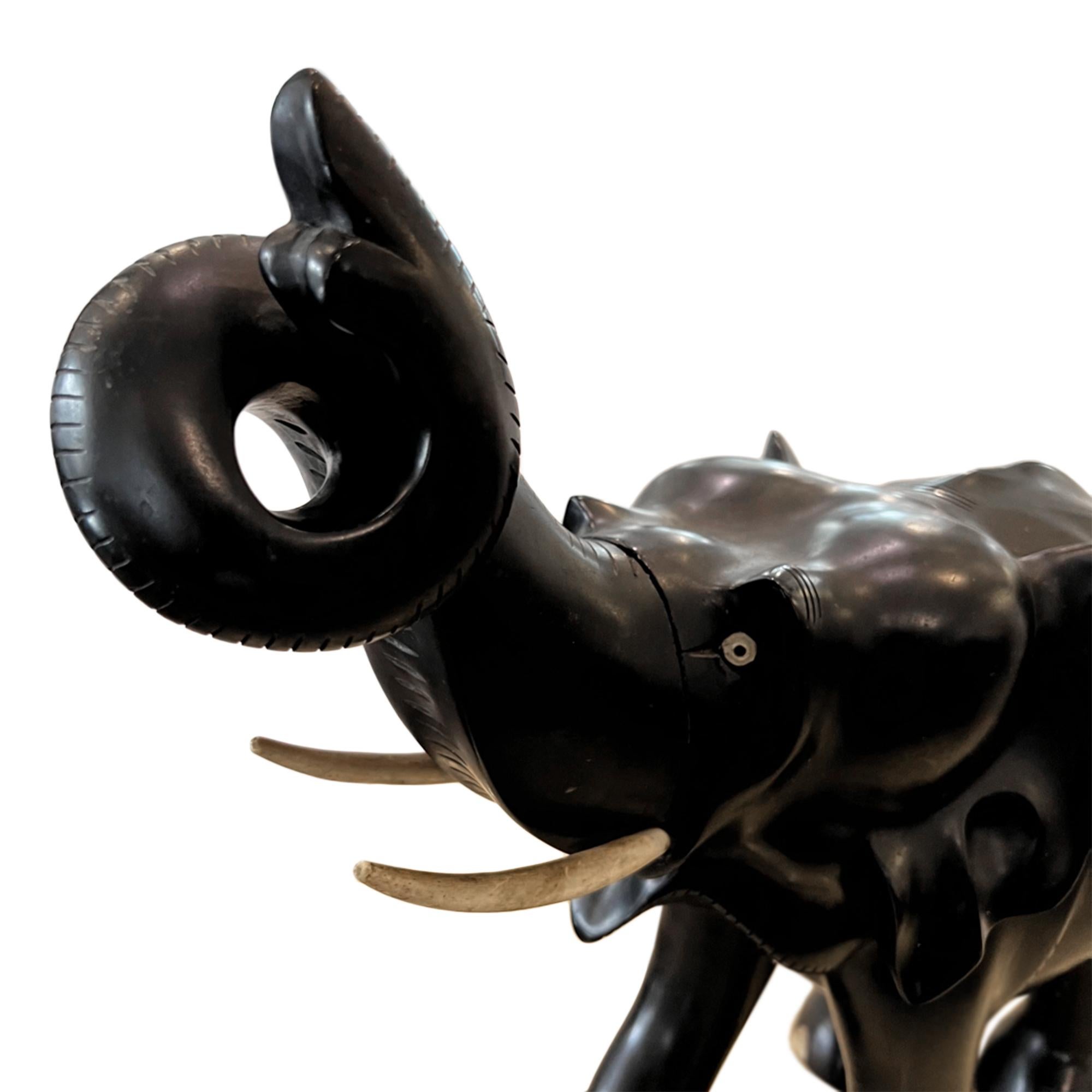 antique wooden elephants with ivory tusks