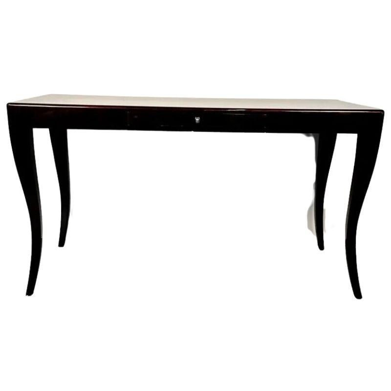 An ebonized and lacquered mahogany desk from Kravet Furniture.  The writing desk features graceful lines, curved and tapered legs and a single drawer with a round, nickel drawer pull.  A super chic and functional piece.