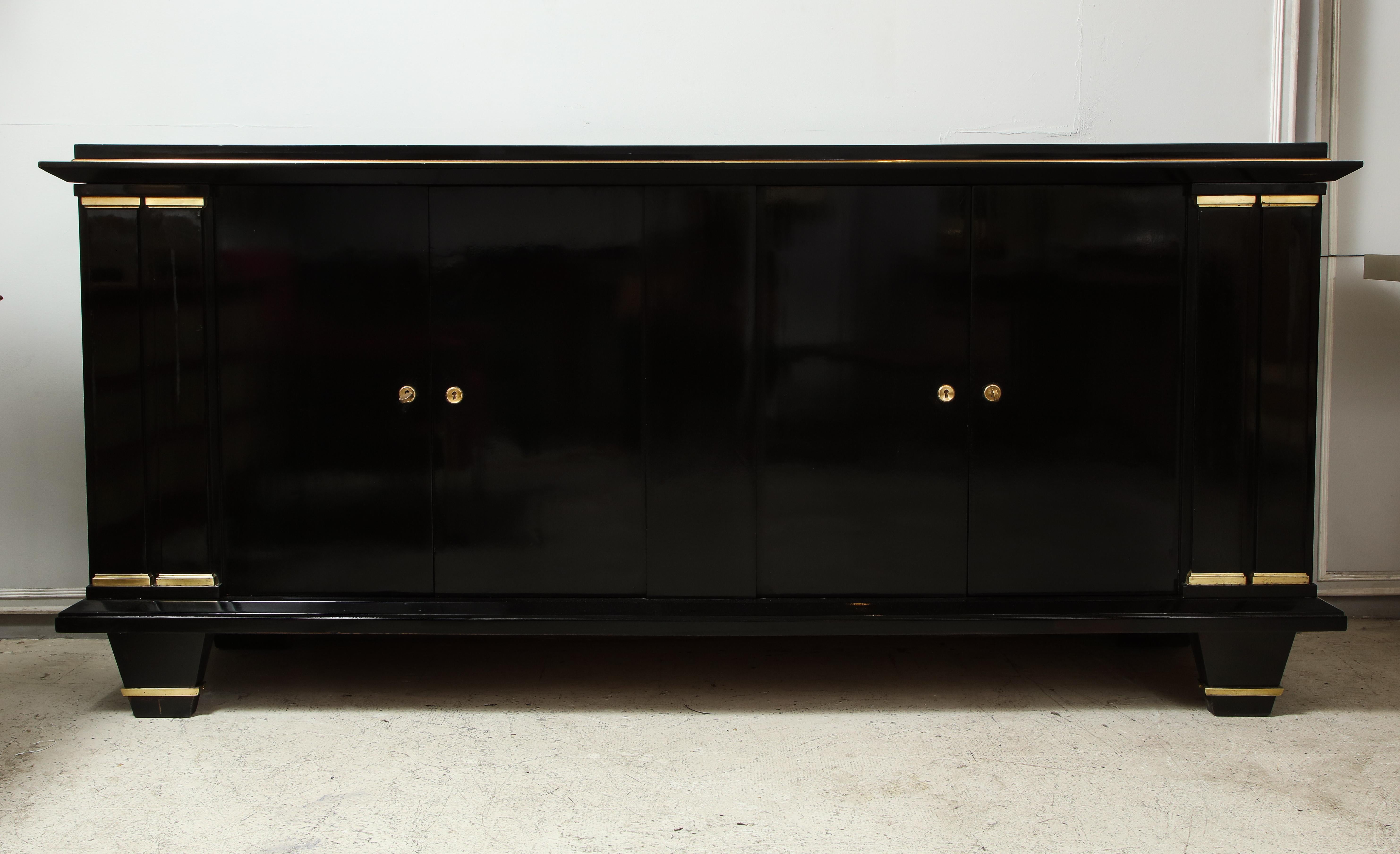 Ebonized architectural sideboard with bronze mounts having pilaster decoration with bronze capitals resting on tapered legs.