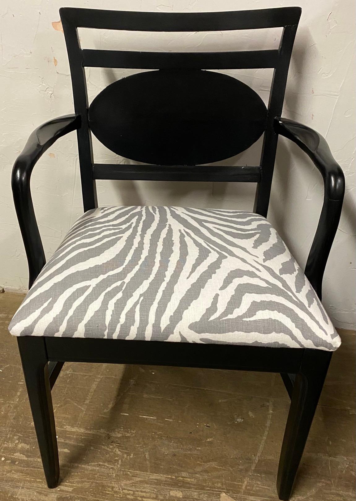 Stylish Art Deco style wood frame office or desk arm chair in black. Chair has a decorative oval medallion on the back and an upholstered seat covered in contemporary grey and white zebra stripes.
Search terms: Mid-Century Modern wood frame office