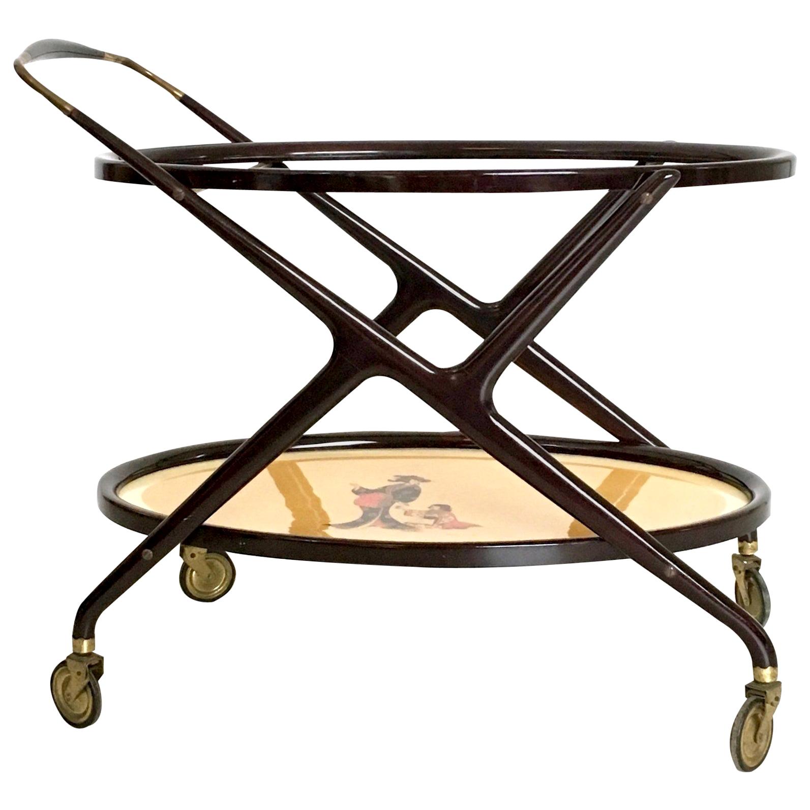 Made in Italy, 1950s.
It features an ebonized beech frame, two glass shelves (one with an oriental paint under it) and brass casters.
This is a vintage item therefore it might show slight traces of use, but it can be considered as is excellent