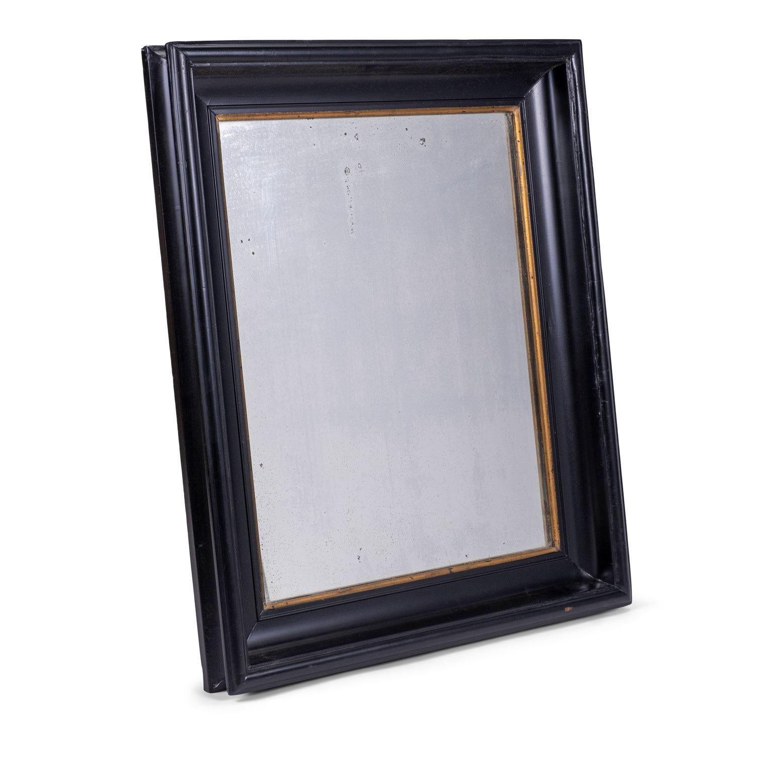 Ebonized Belgian mirror trimmed in giltwood. Dates to late 19th century. Original mirror glass.