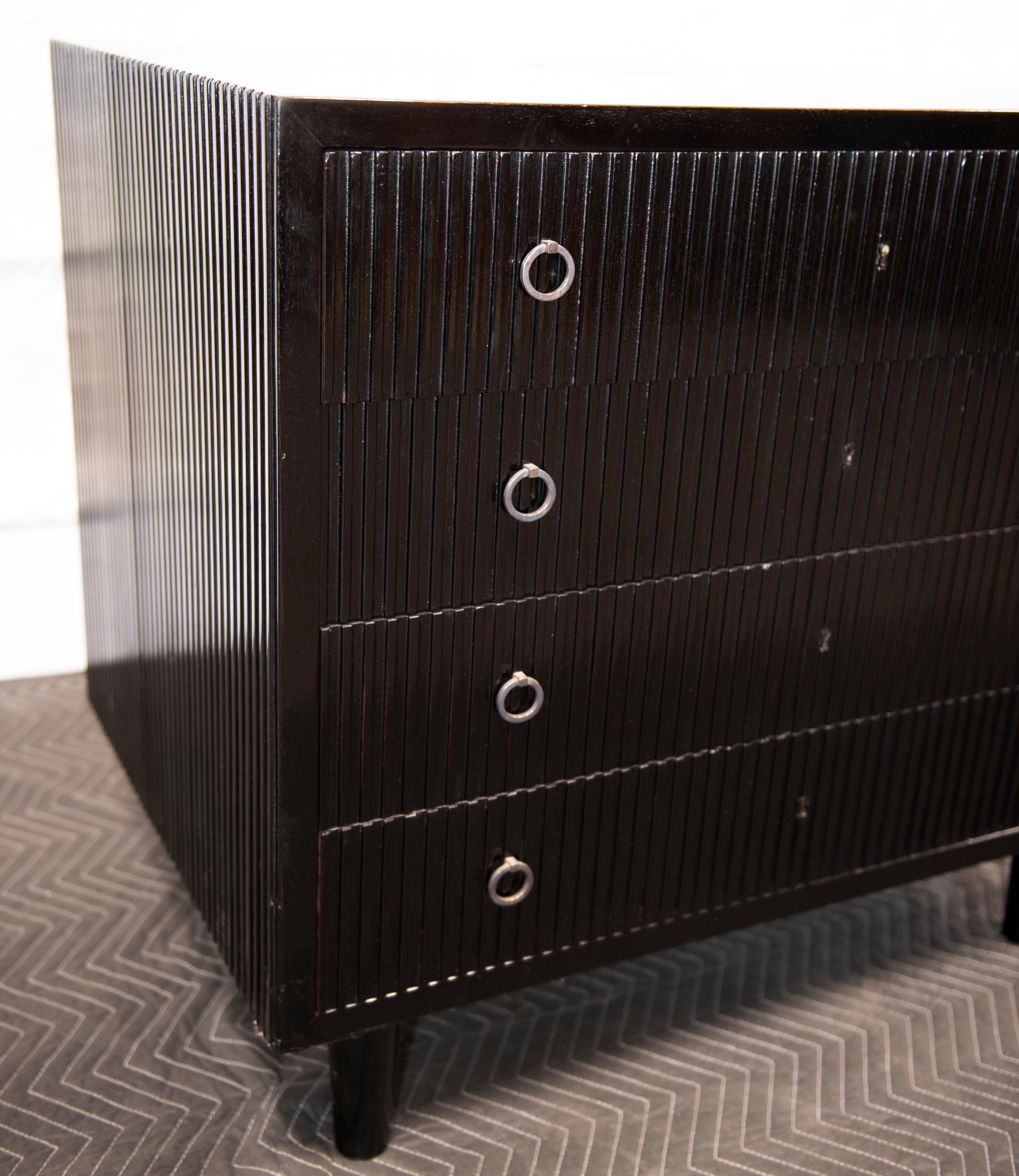 Painted and ebonized ribbed birch 4-drawer commode/case piece, or cabinetry on tapered, round legs, circa 1930. Although the artist is unknown, this piece was purchased from one of the most reputable dealers in cabinetry, and purchased at a premium