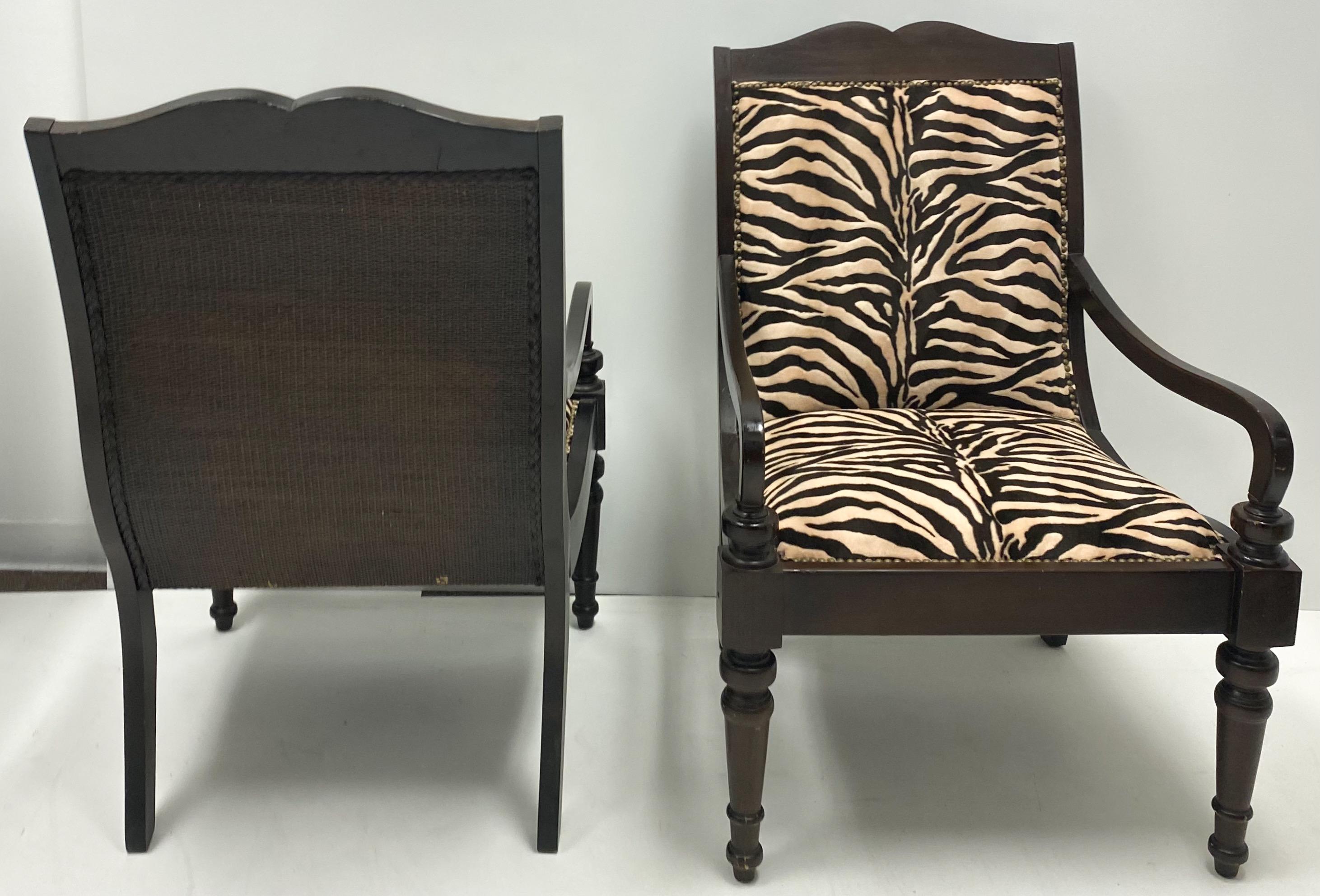 These make a strong statement! This is a pair of British Colonial style chairs in a printed zebra velvet. Brass nailheads add a finishing touch. They are marked and in very good condition.