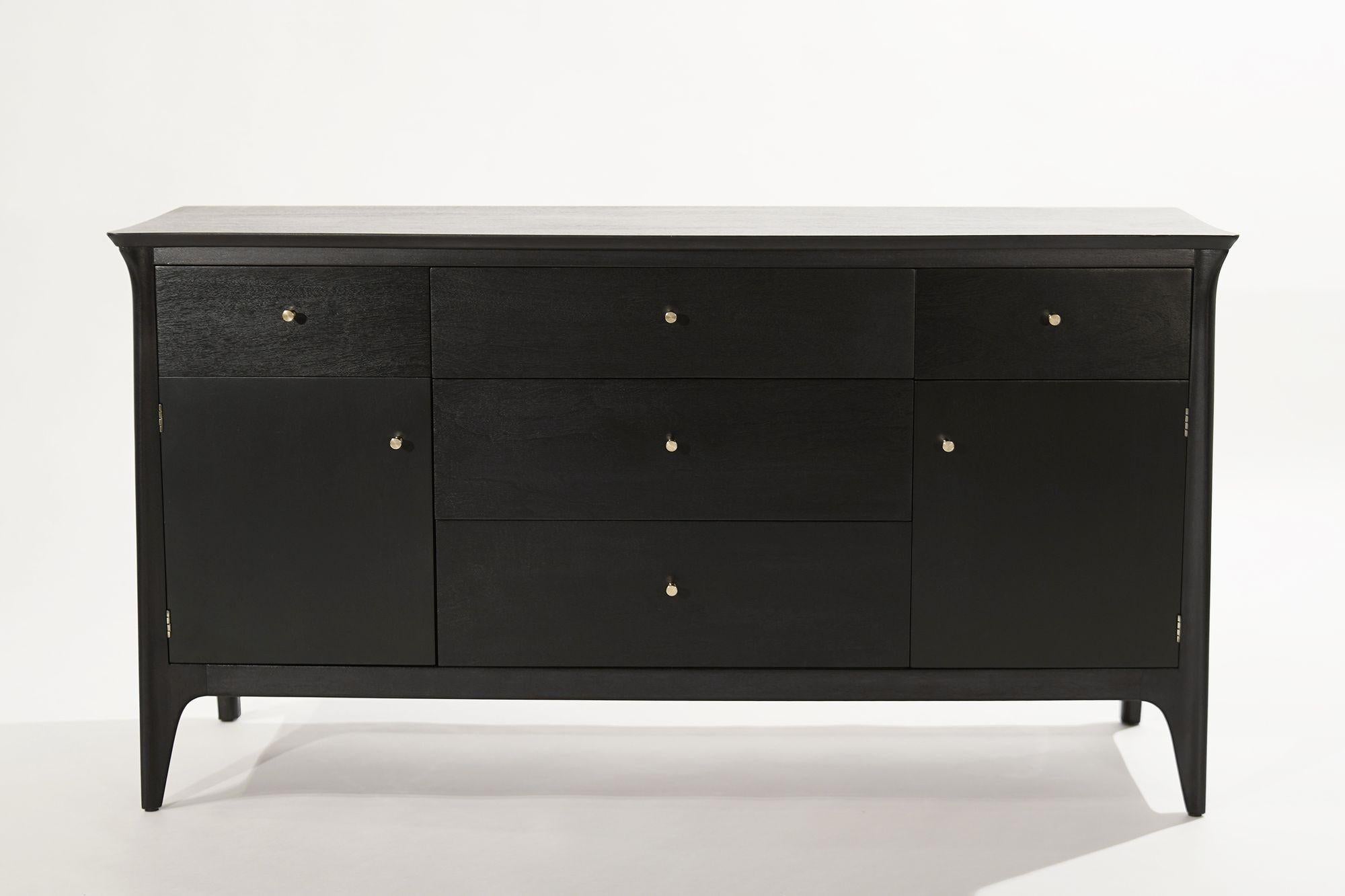 A beautifully restored credenza or buffet designed by Kipp Stewart for Drexel, USA, circa 1950-1959, executed in mahogany redone in our ebonized finish. Features five drawers and side doors containing shelving. 
 
Other designers from this period