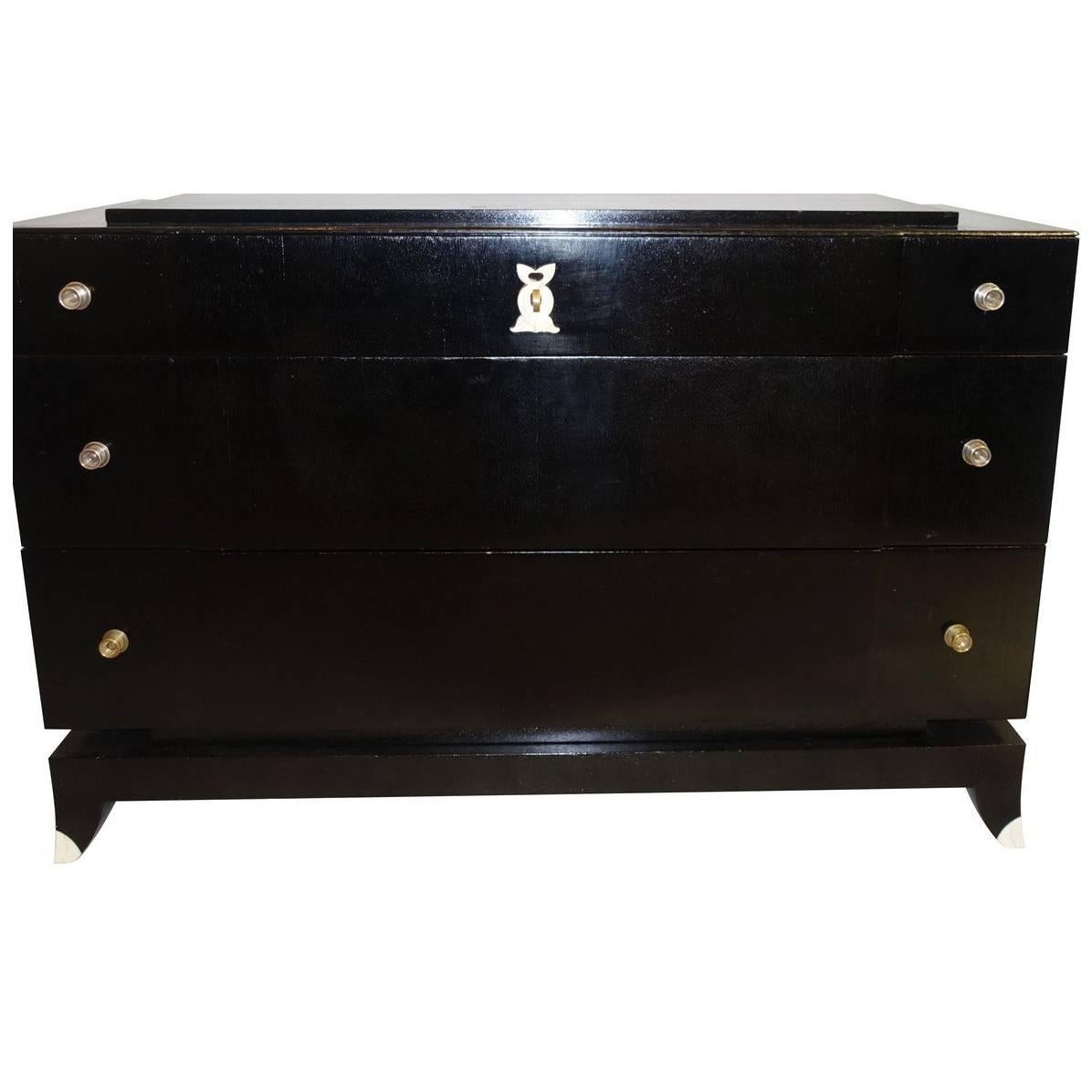 1930s French ebonized mahogany three drawer commode with tipped legs.
Unusual raised top.
Polished nickel pulls.
