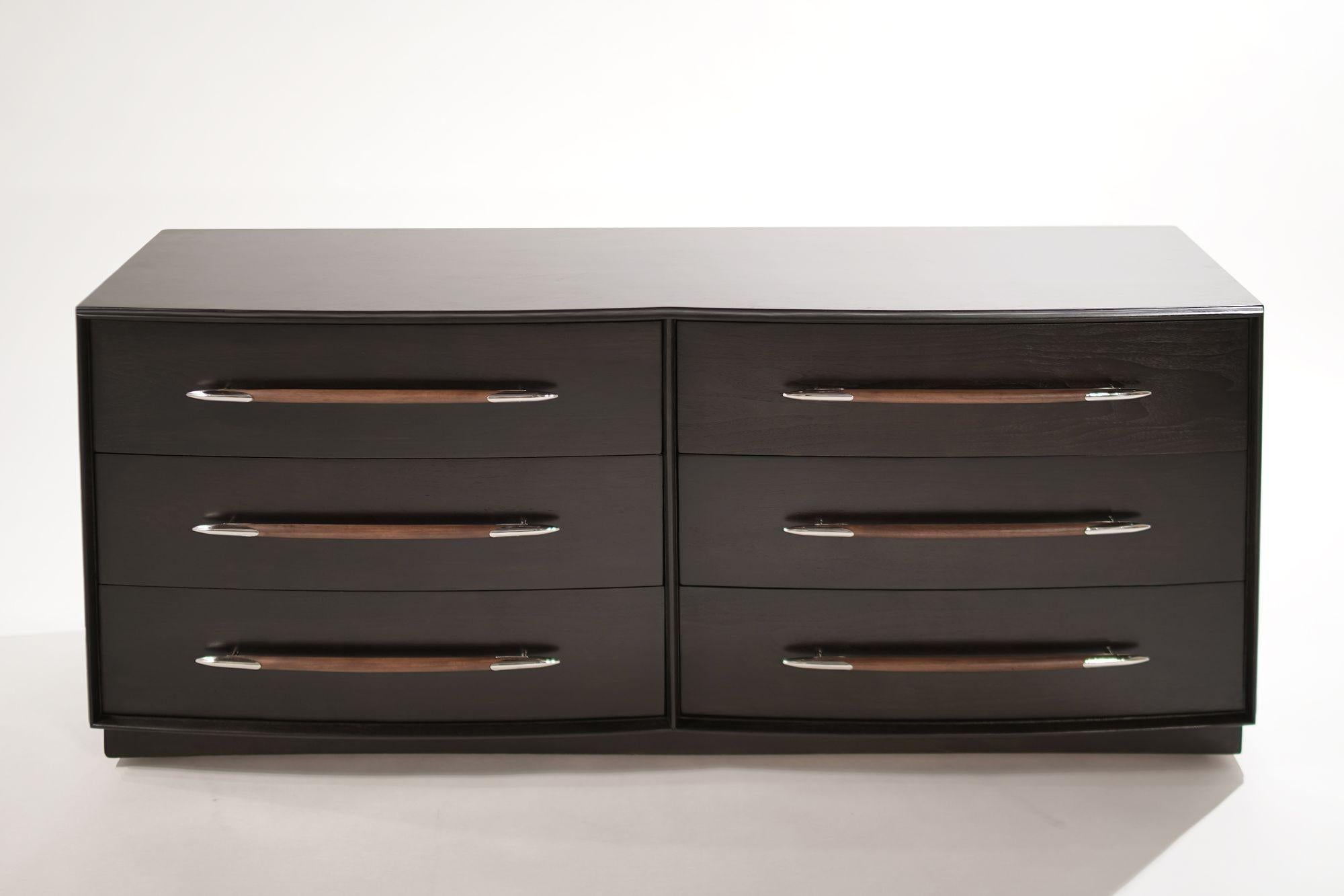 A six-drawer walnut dresser designed by T.H. Robsjohn-Gibbings for Widdicomb, circa 1950-1959. Completely restored and ebonized, featuring contrast walnut hardware with nickel spear tips. The six drawers are very large and allow ample storage