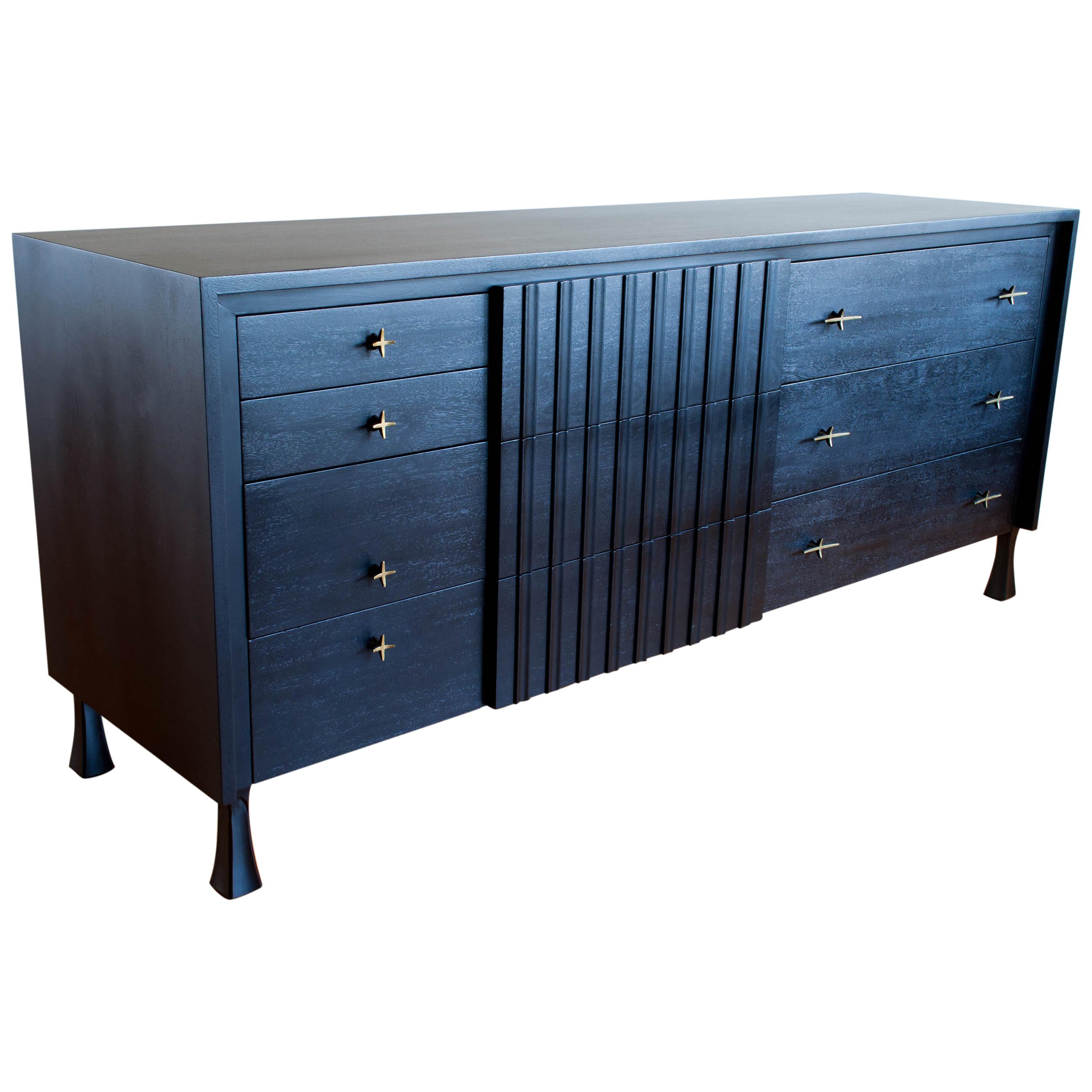 Gorgeous credenza by John Widdicomb that has been professionally restored with an ebonized finish allowing the beautiful grain to still show through. This fantastic dresser is exceptionally well made and features 10 dovetailed drawers of ample