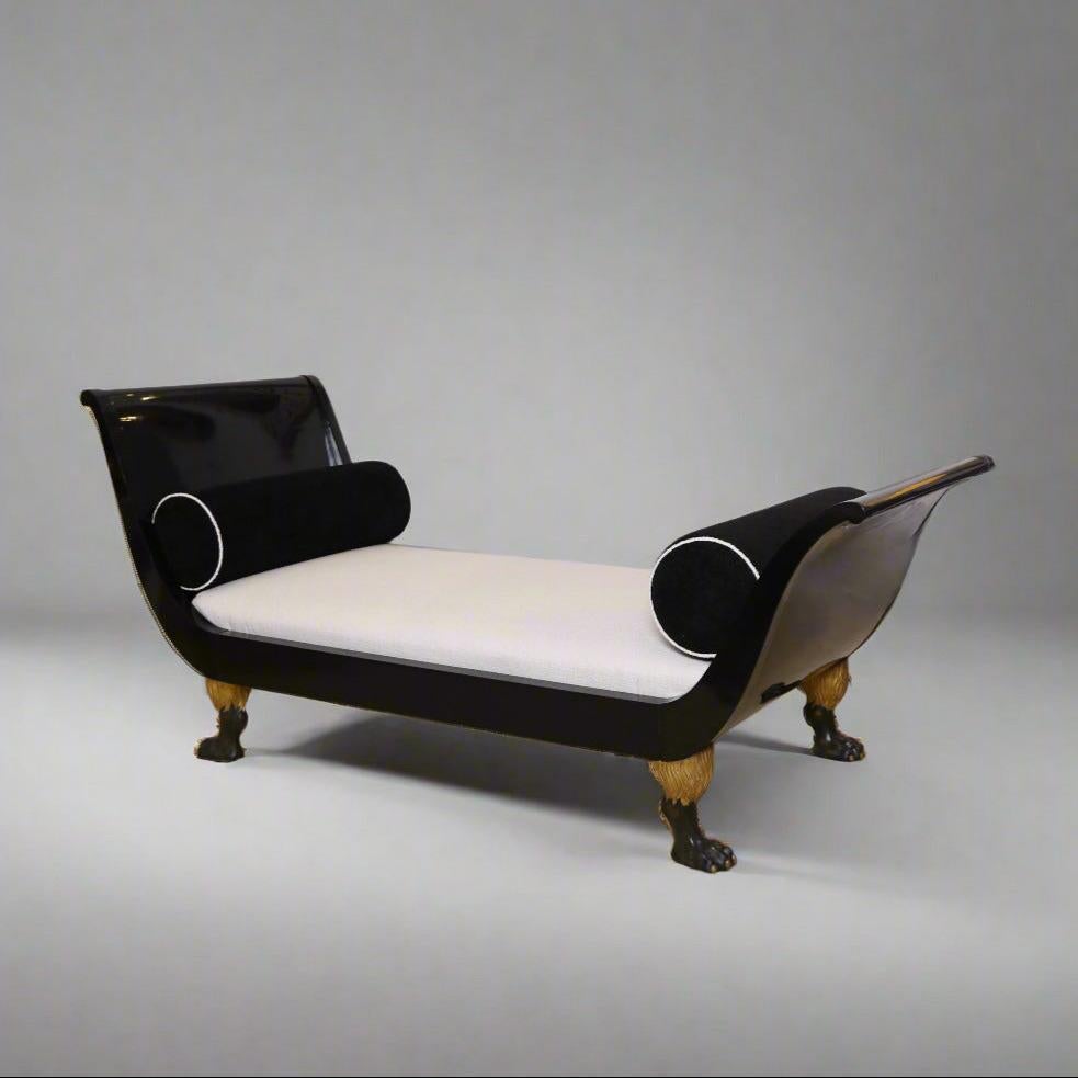 Fine ebonized Austrian Empire recamiere. Ebonized wood featuring elegantly curved sides and four highly detailed carved lions paw feet with giltwood accents.This fully restored large and roomy recamiere offers both elegance and comfort in any