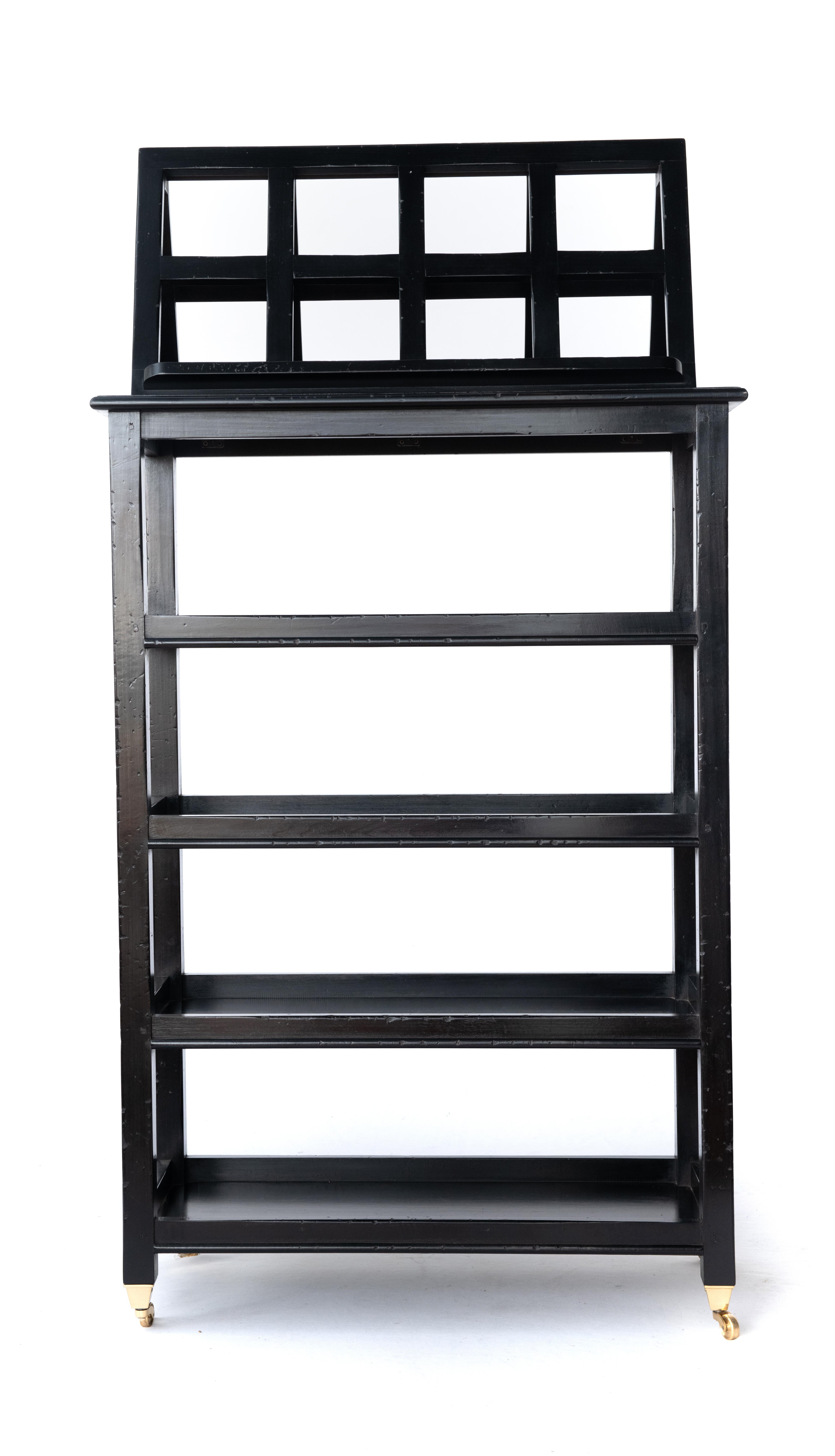 A most stylish four-tier étagère with folding lectern or book stand on solid brass casters. The removable folding lectern is ideal for the display of books, maps, or art. Finished on all sides so it can float in a room with books or artwork