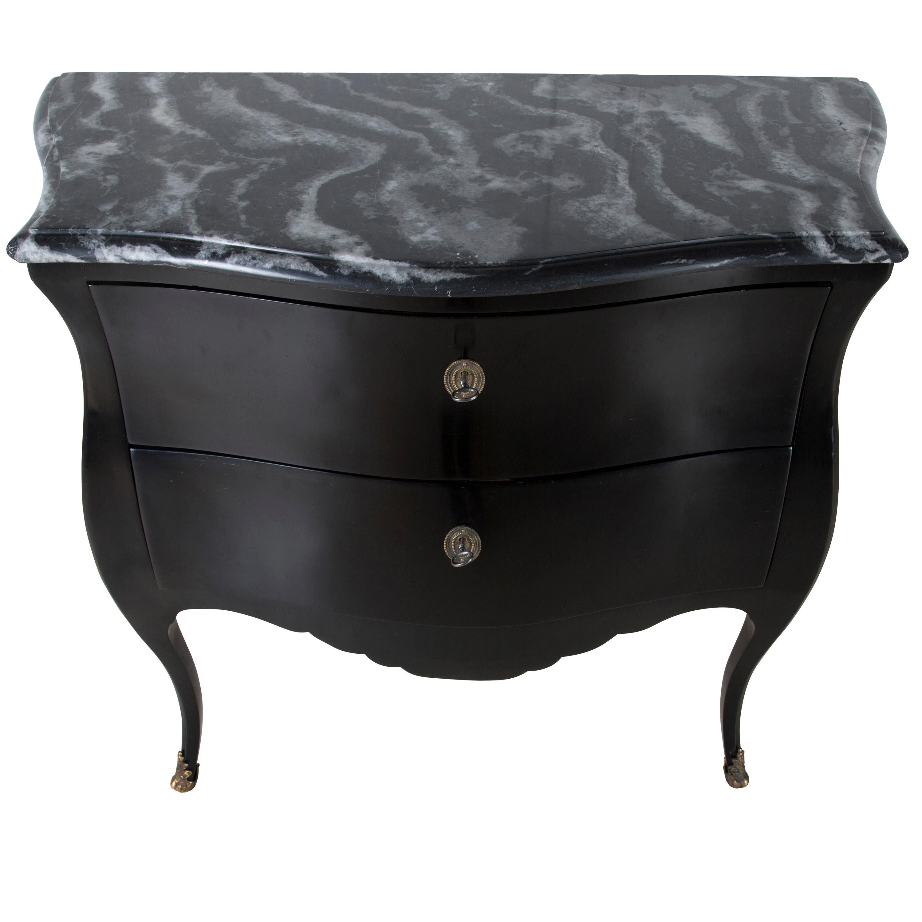 A strikingly simple and shapely 19th century French bombe commode with stunning black and white marble top. Later ebonized, circa 1880.