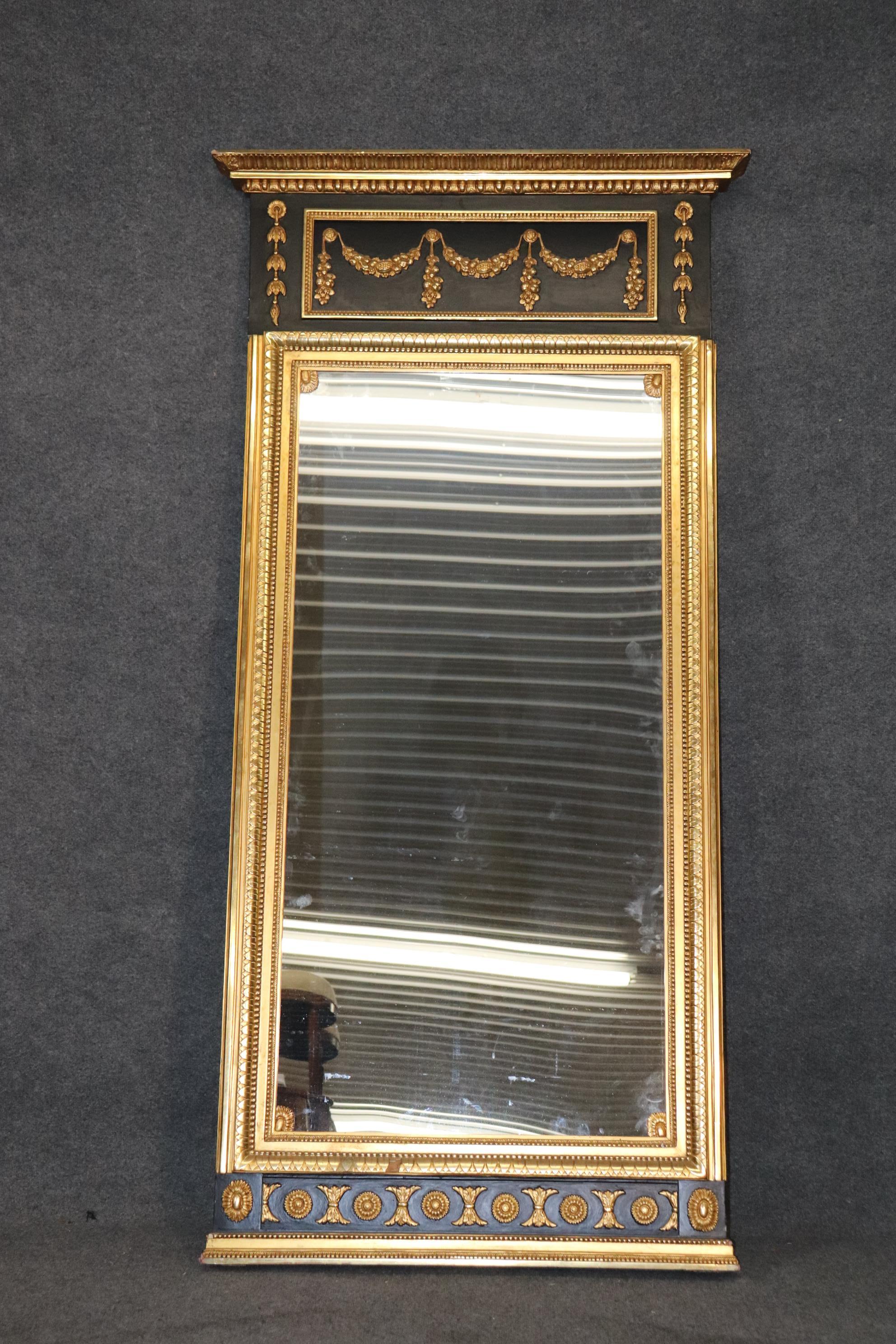 This is a beautiful Italian-made French Empire style wall mirror. The mirror is not beveled and is in good condition and has only minor signs of wear and use. Measures 78.75 tall x 38.75 wide x 5 inches deep.