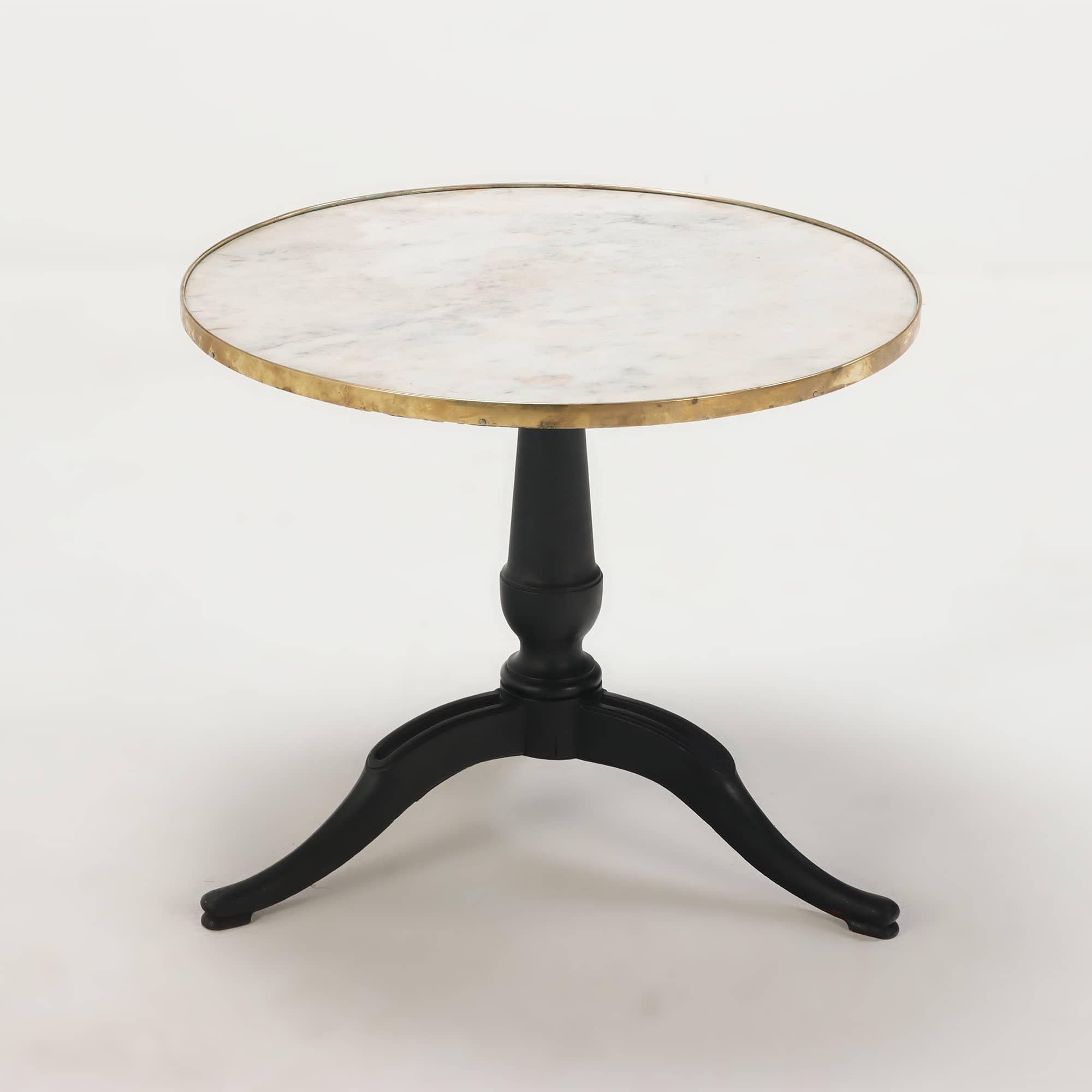 A French marble top occasional table having a turned ebonized base supporting a white marble top with a brass trim circa 1880.