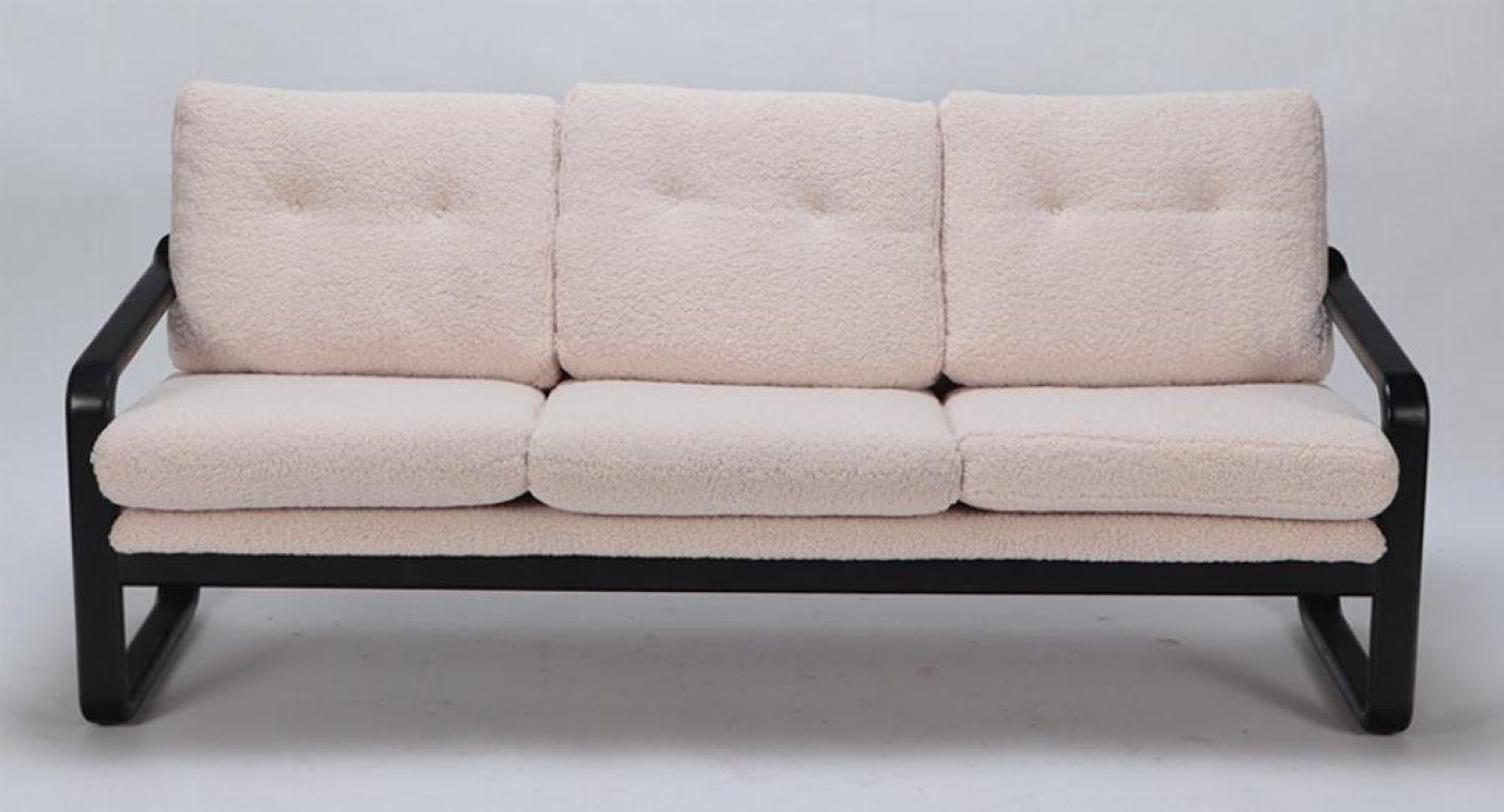 Mid-Century Modern Ebonized French three seat sofa recently upholstered in Boucle fabric For Sale