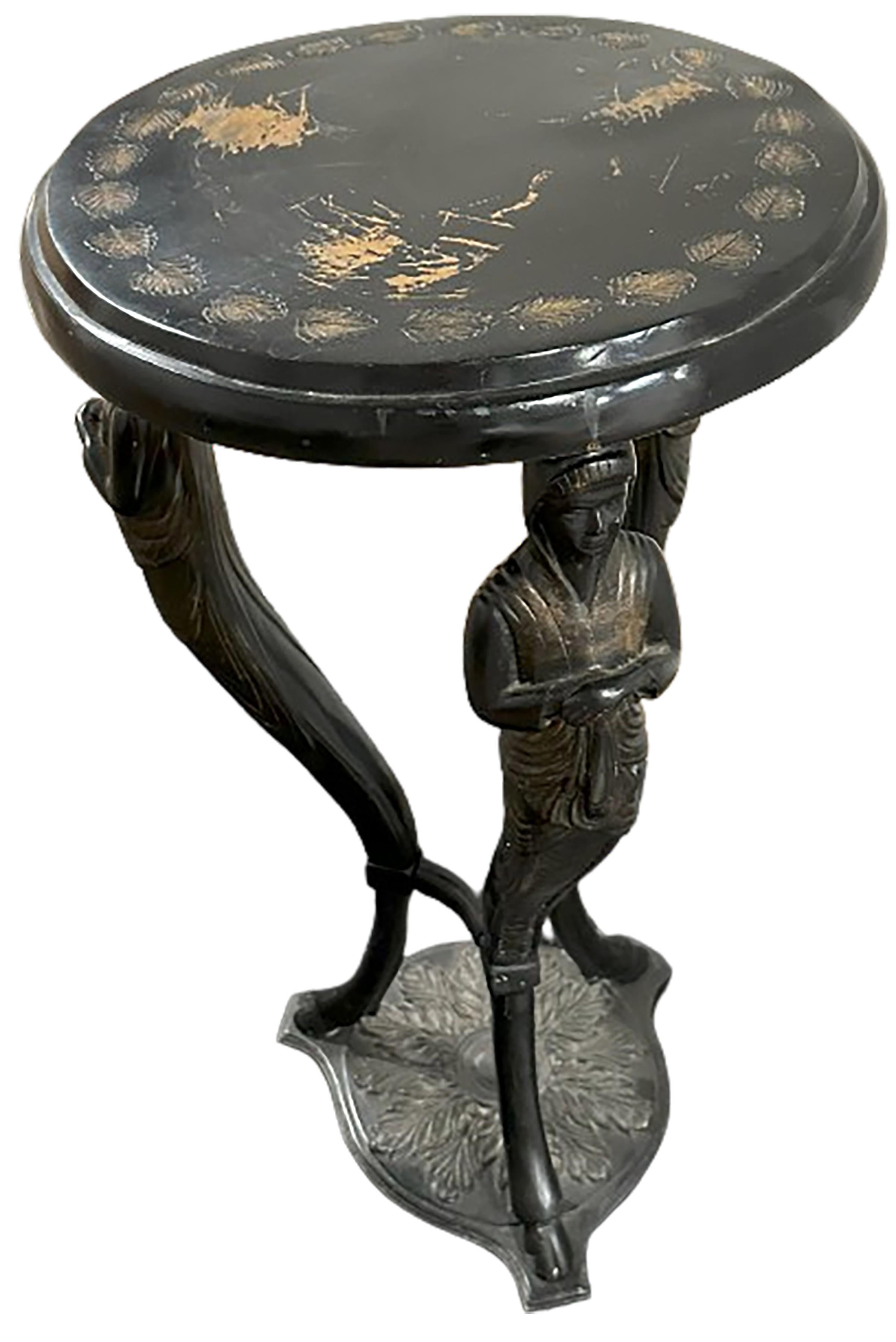 A charming, ebonized metal side table with three siren figures. Removable top that rest on screws. Siren-like figures prop up the table on three sides. Beautifully cast leaf patterns on the top of the base. The figures morph into a single hoofed