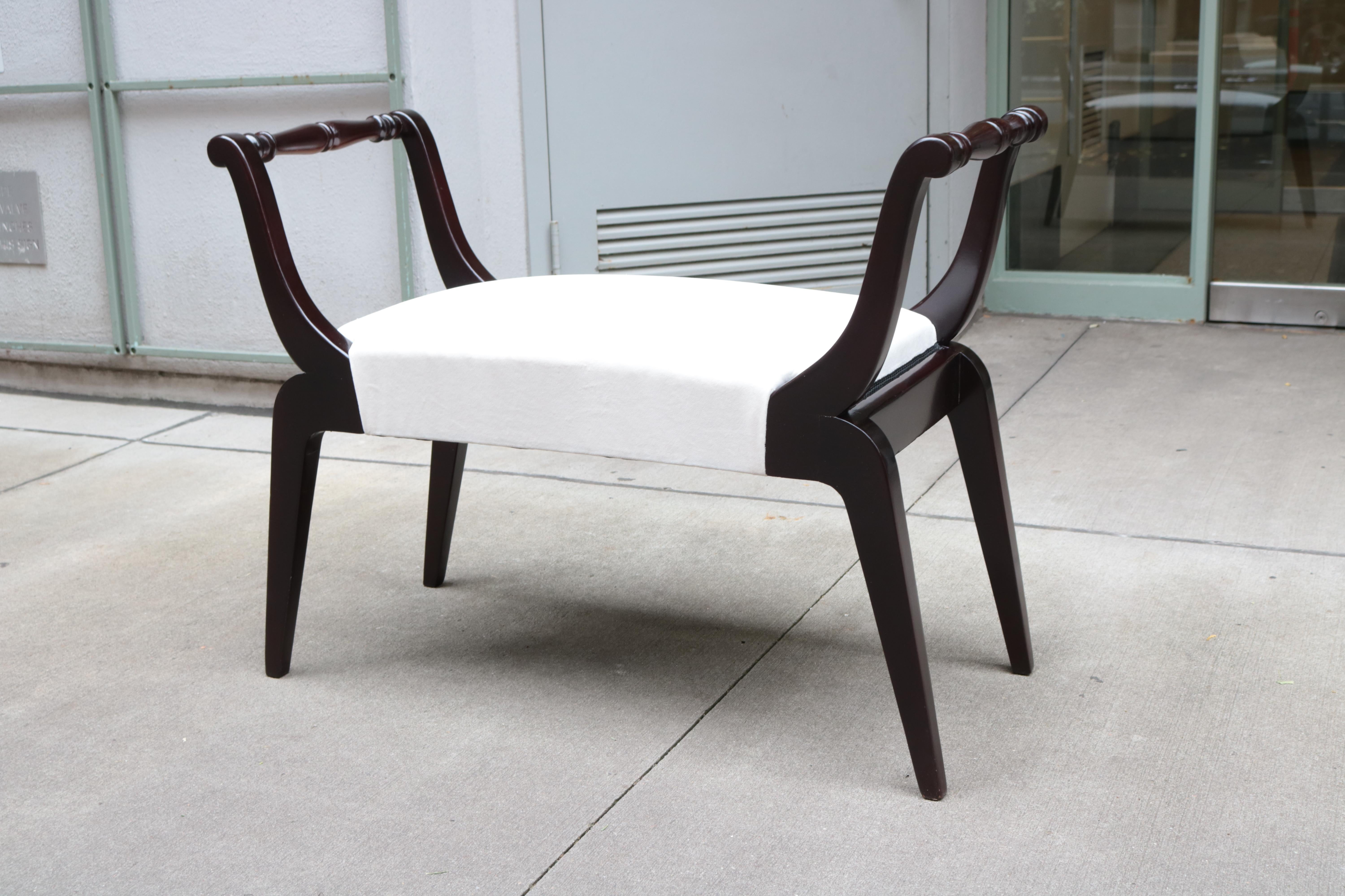 An ebonized Italian Mid Century bench.
Ebonized Beech wood with tapered legs and 
carved detaials on the armrests.