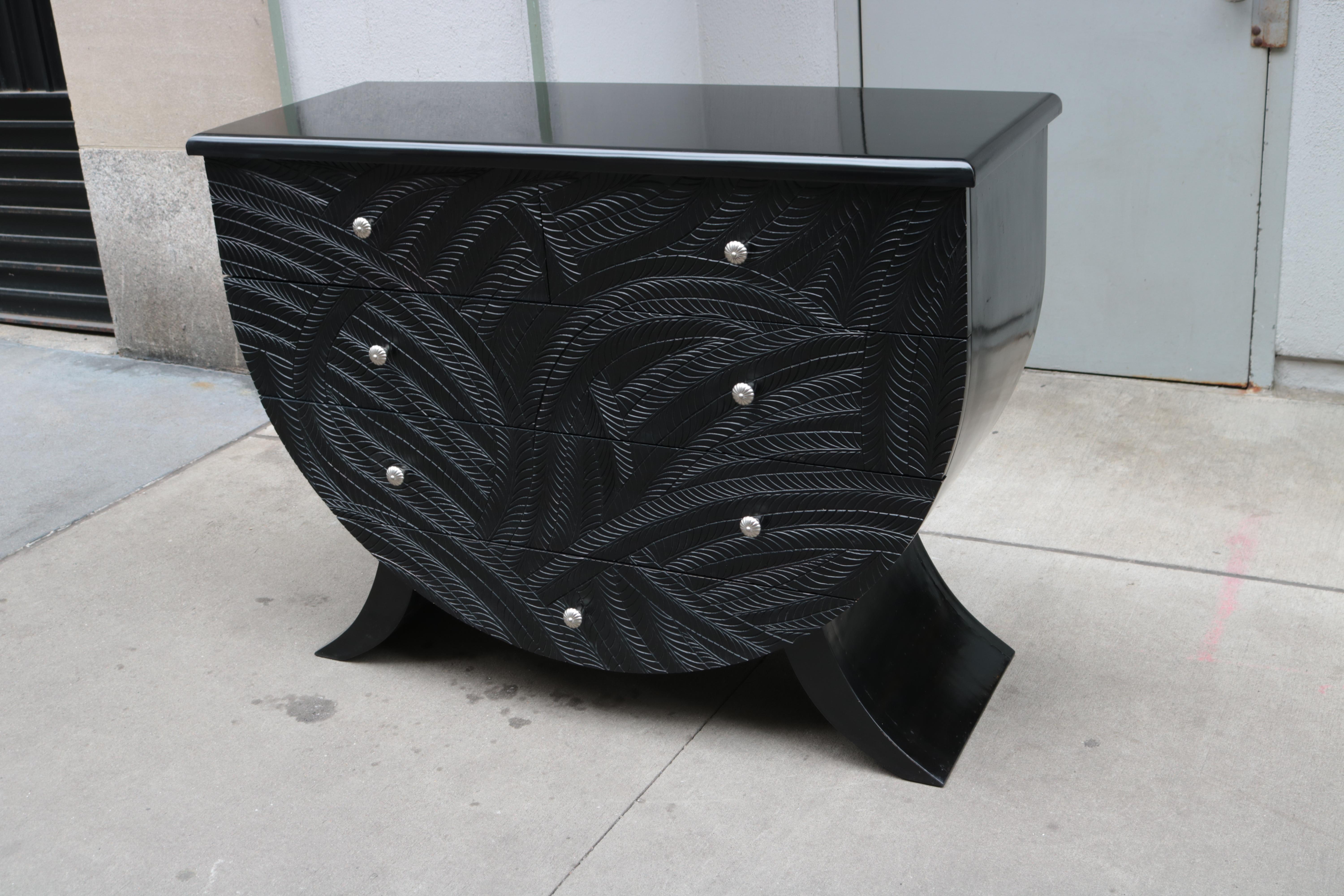 An ebonized Italian Modernist chest of drawers.
Ebonized wood with highly detailed carvings 
on the drawer fronts and nickeled pulls.