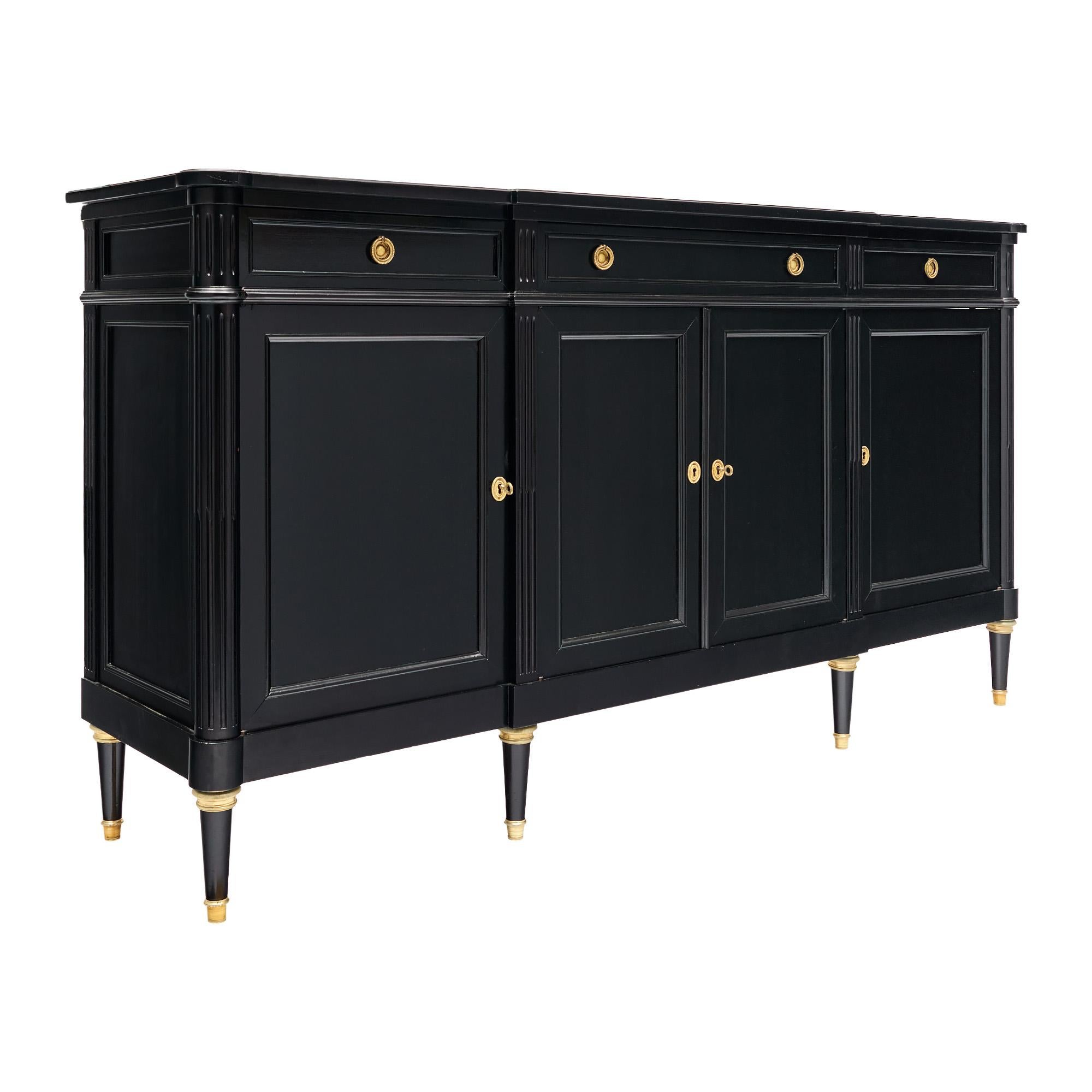 Buffet from France in the Louis XVI style. This piece is made of solid wood construction, primarily mahogany. It has been ebonized and finished with a lustrous French polish of museum-quality. There are three dovetailed drawers - one long drawer in