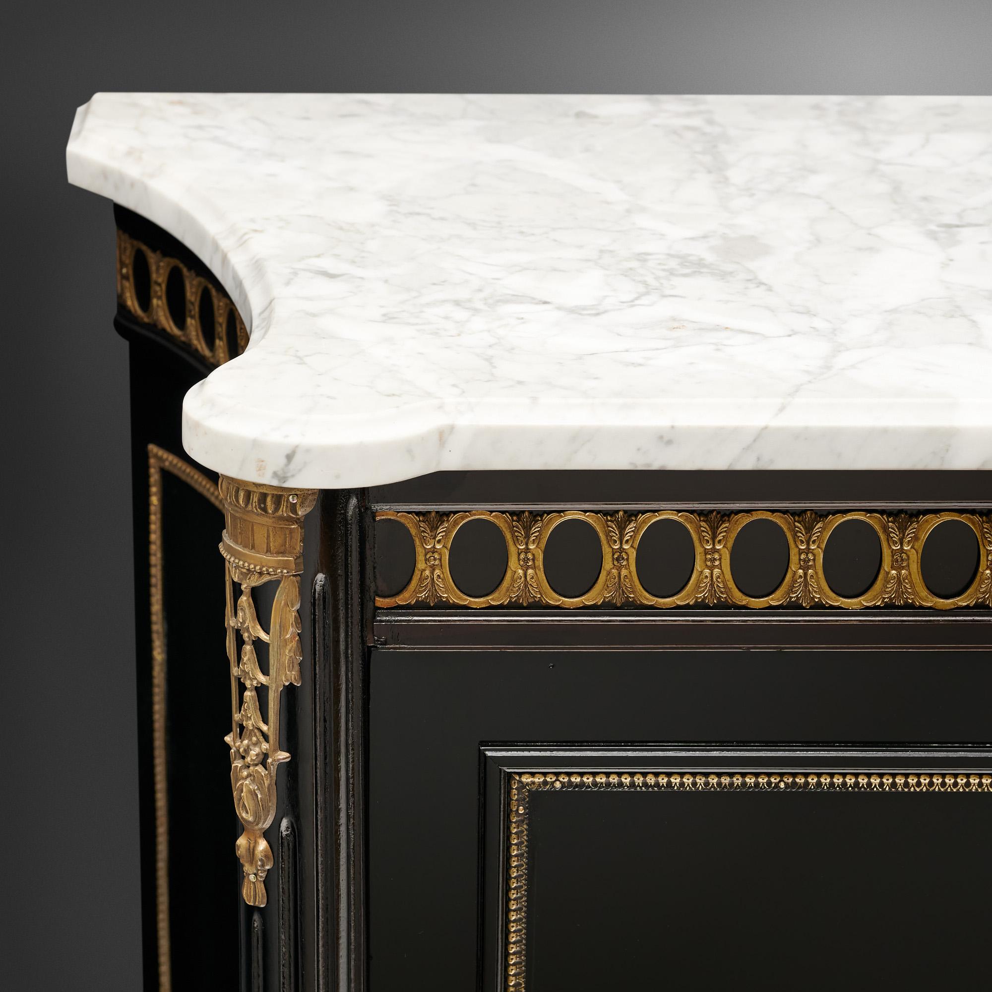 Buffet from France in the Louis XVI style. This enfilade is made of mahogany that has been ebonized and finished with a lustrous French polish of museum-quality. There are four doors that open to interior shelving. In the upper traverse the