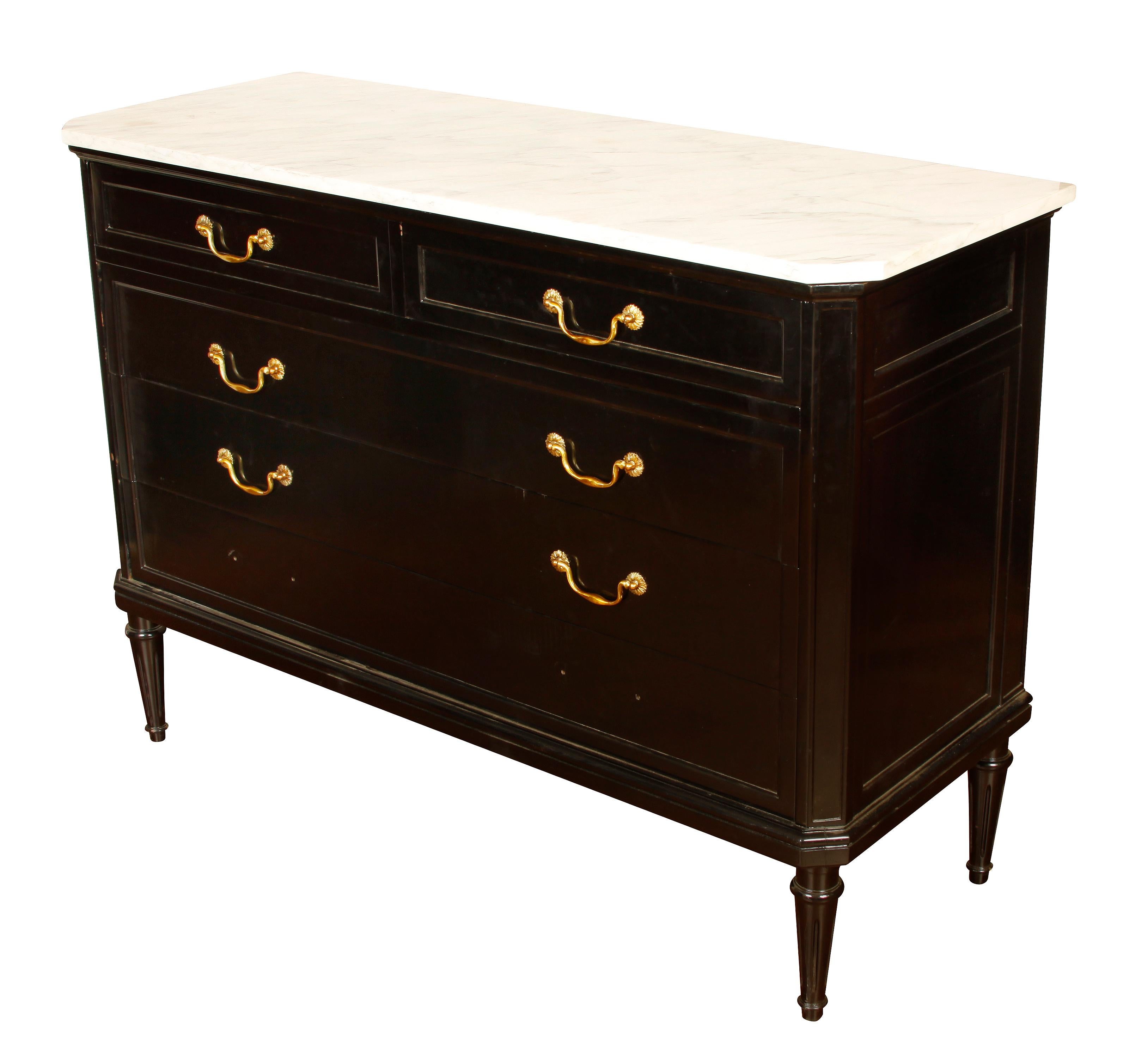 Louis XVI style, ebonized marble-top commode, circa 1940 with drop bail drawer hardware and straight, reeded legs.