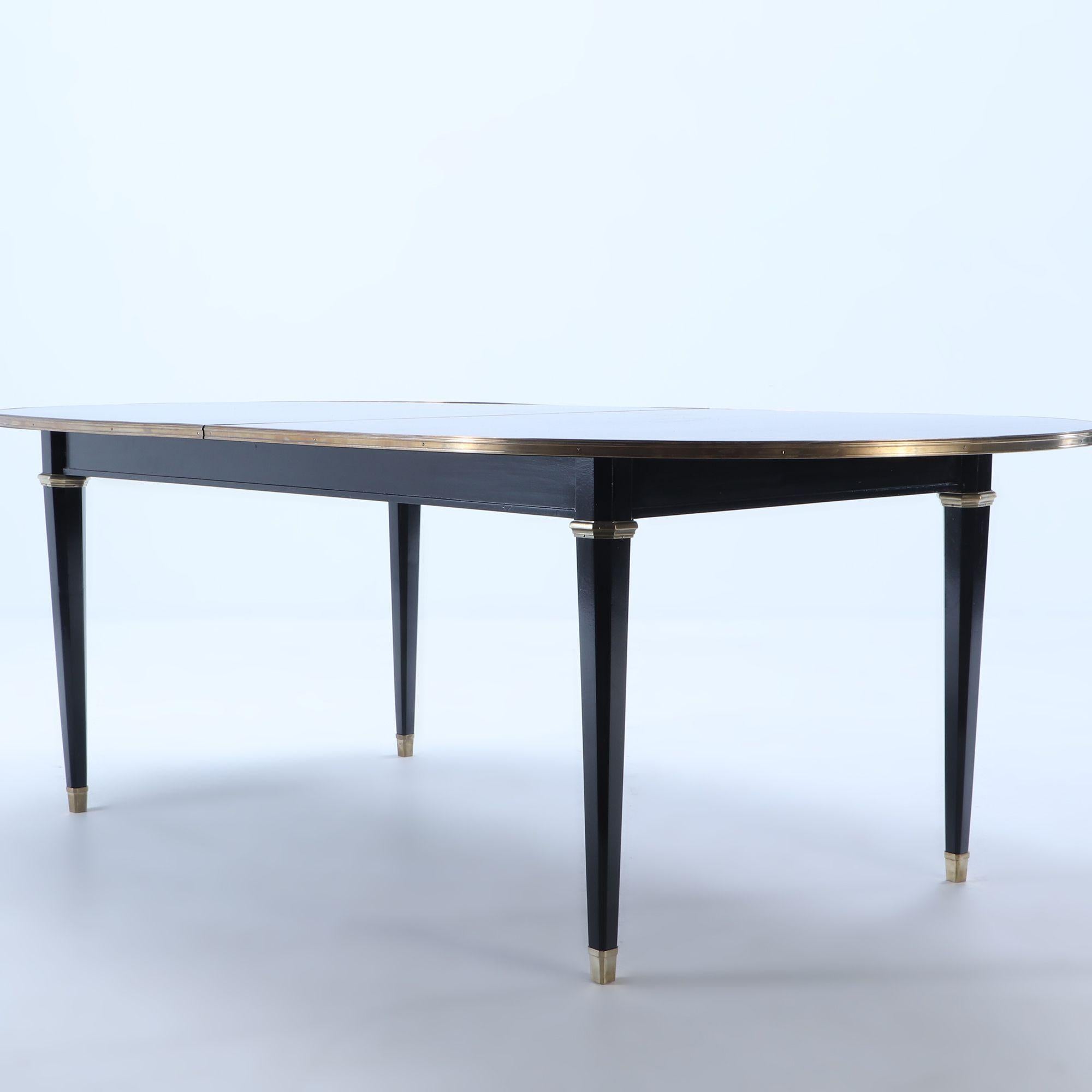 Ebonized mahogany dining room table C 1940 attributed to Maison Jansen C 1940. This table was recently discovered in Buenos Aires Argentina where the Jansen firm had a factory and office. The table has a bronze banding on the edge of the top and