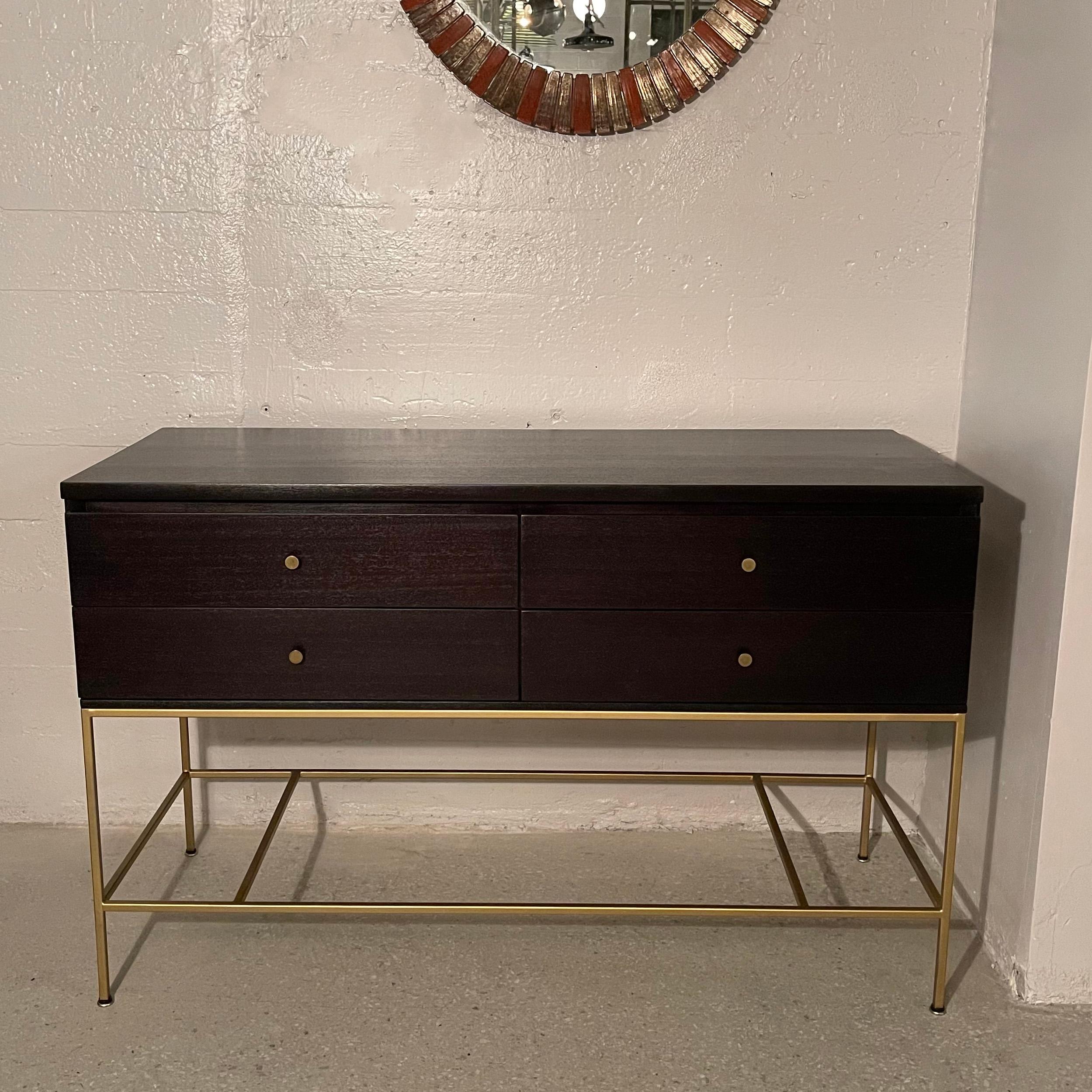 Mid-Century Modern, sideboard cabinet by Paul McCobb for Calvin features a 4 drawer ebonized mahogany top on a minimal gilt steel frame with brass pulls. The sideboard is finished on the back as well.