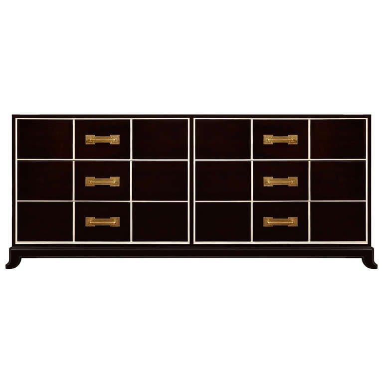 An ebonized mahogany 6 drawer dresser with highlighted recessed detail and brass pulls by Tommi Parzinger, American C. 1940's