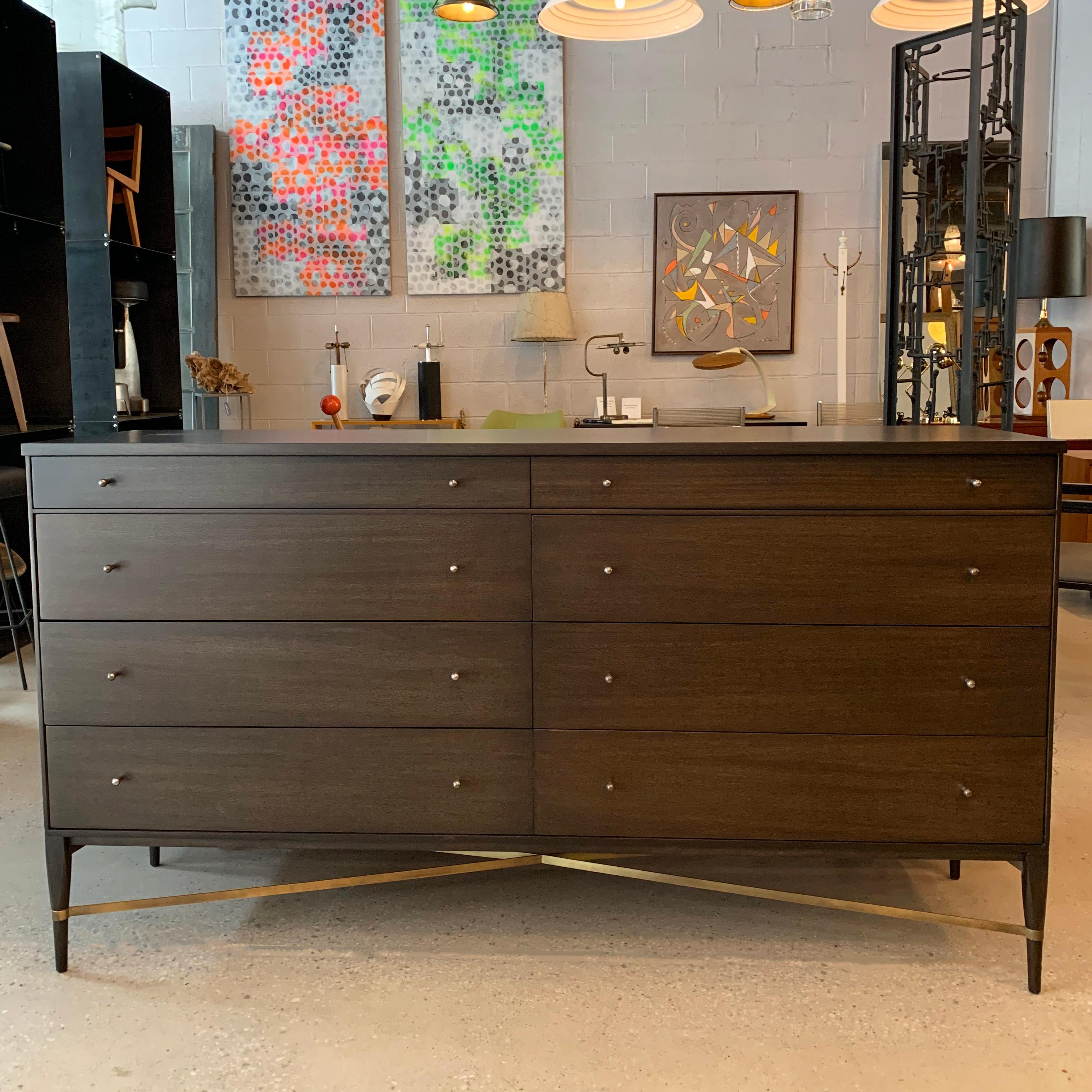 Mid-Century Modern, 8-drawer, ebonized maple dresser by Paul McCobb for Calvin features brass stretcher and signature hourglass pulls.