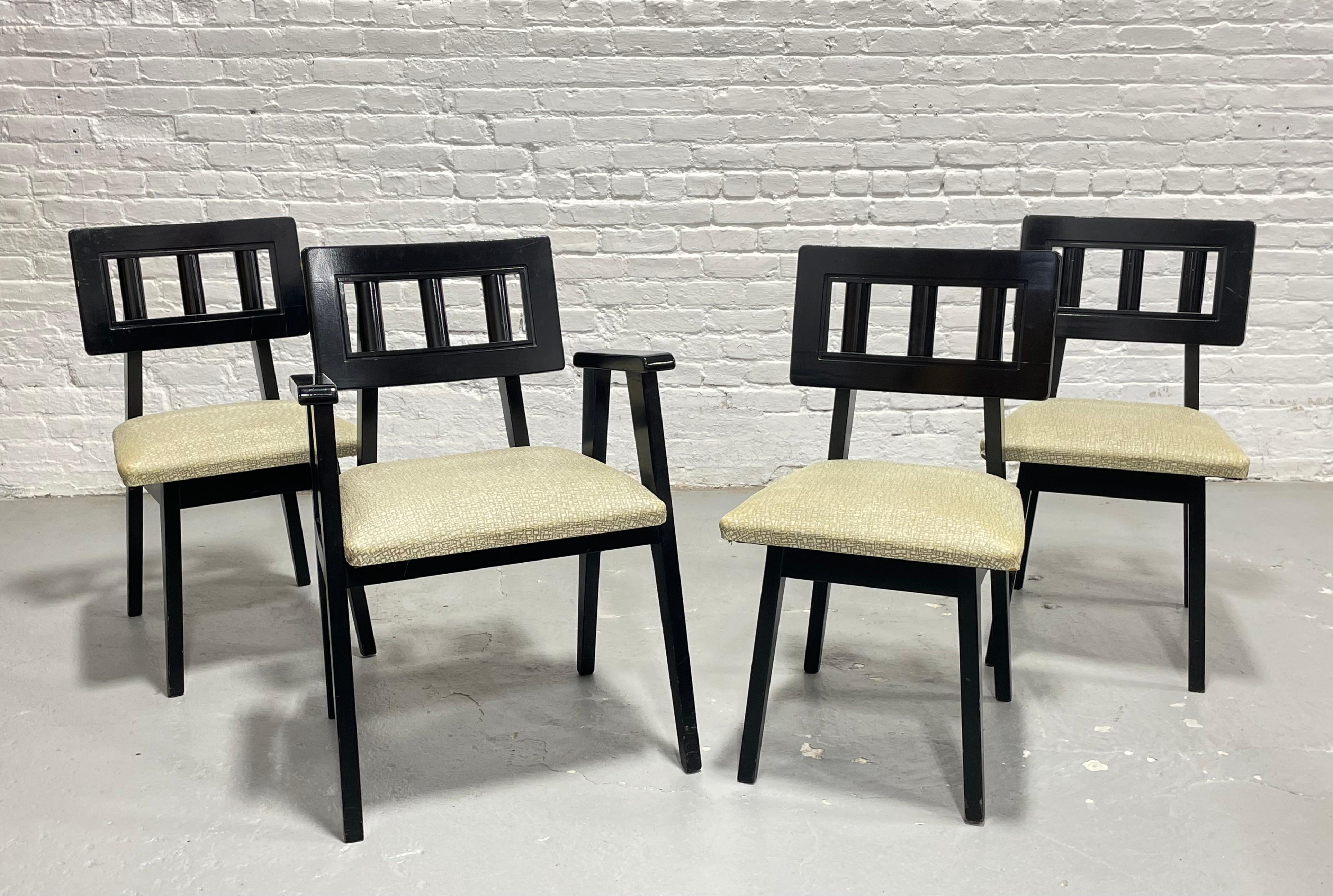 Set of Four Mid Century Modern Ebonized Dining Chairs, c. 1950's.  The square spindled back supports are funky yet comfortable and the oatmeal colored vinyl upholstery contrasts beautifully with the black ebonized frames. Seats are plush and comfy