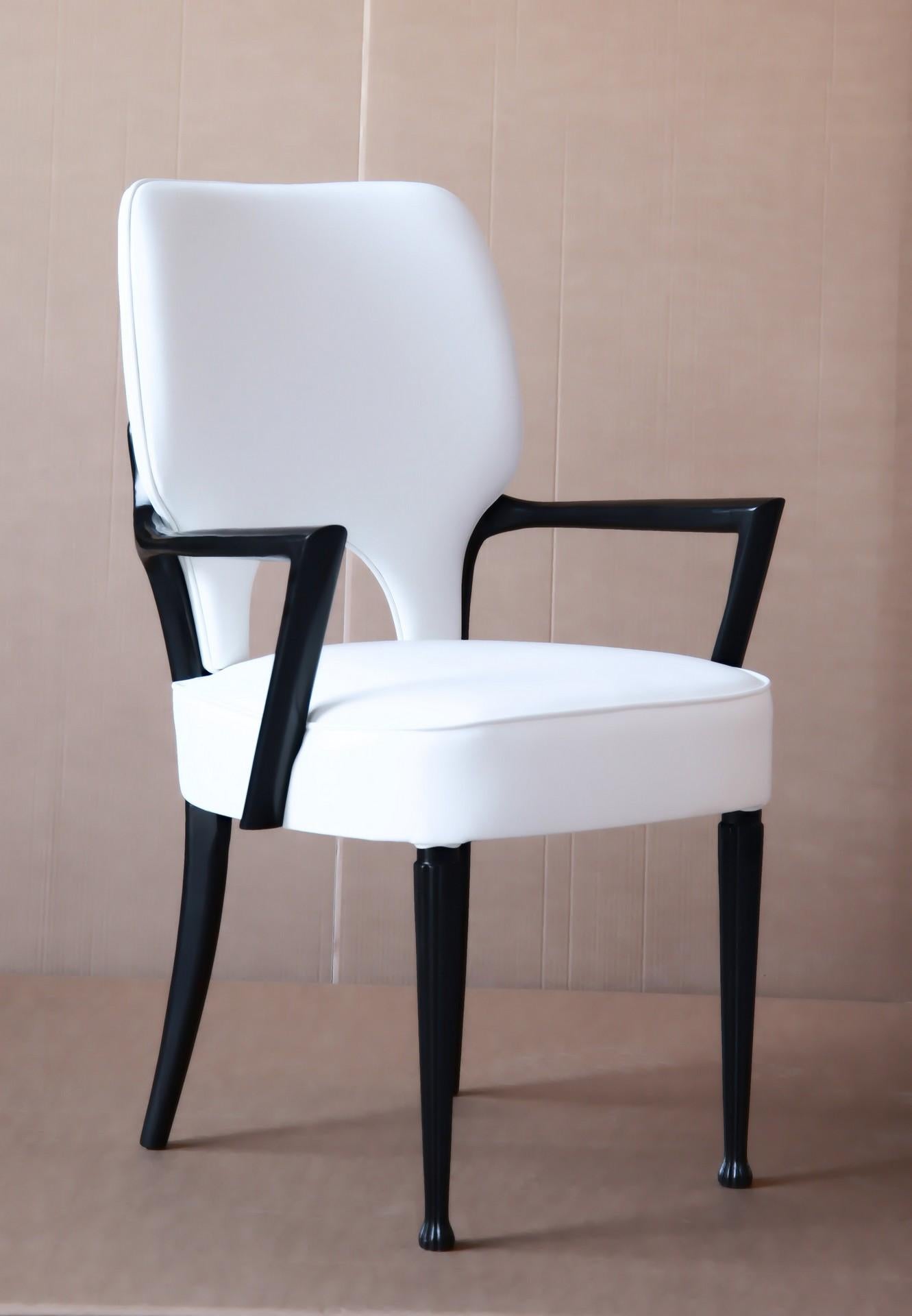 Charming modernist design armchair. Perfect dining arm-chair. The Silhouette design is organic and rounded on both the visible wood on armrest and legs and the upholstered part.
Curves on upholstery are gently highlighted with a same leather piping.