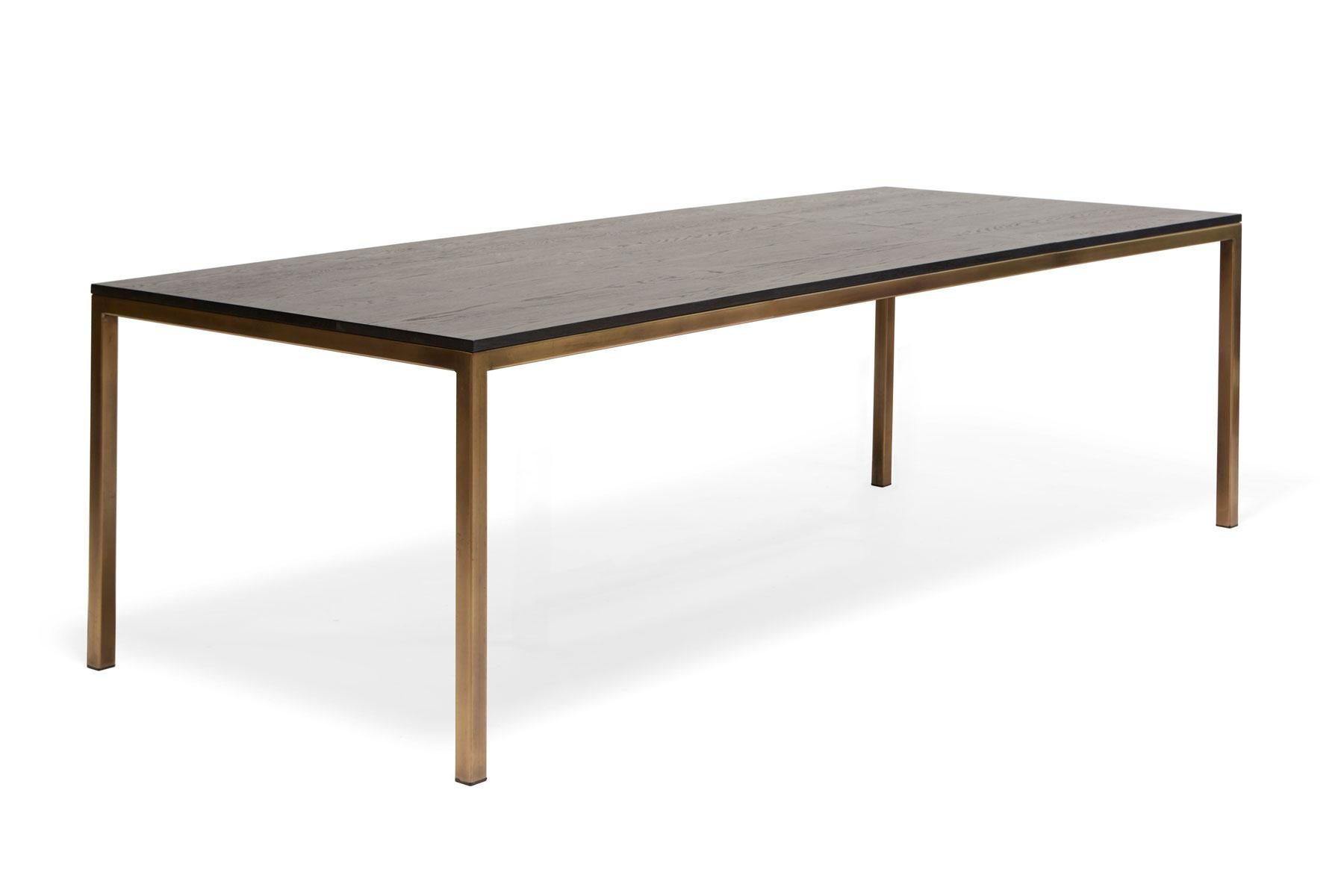 A solid oak and steel dining table, perfect for seating 6-10 people comfortably. This version has an antique brass frame finish and an ebonized oak tabletop. White oak, walnut, or maple wood top and various frame finish options are also available.
