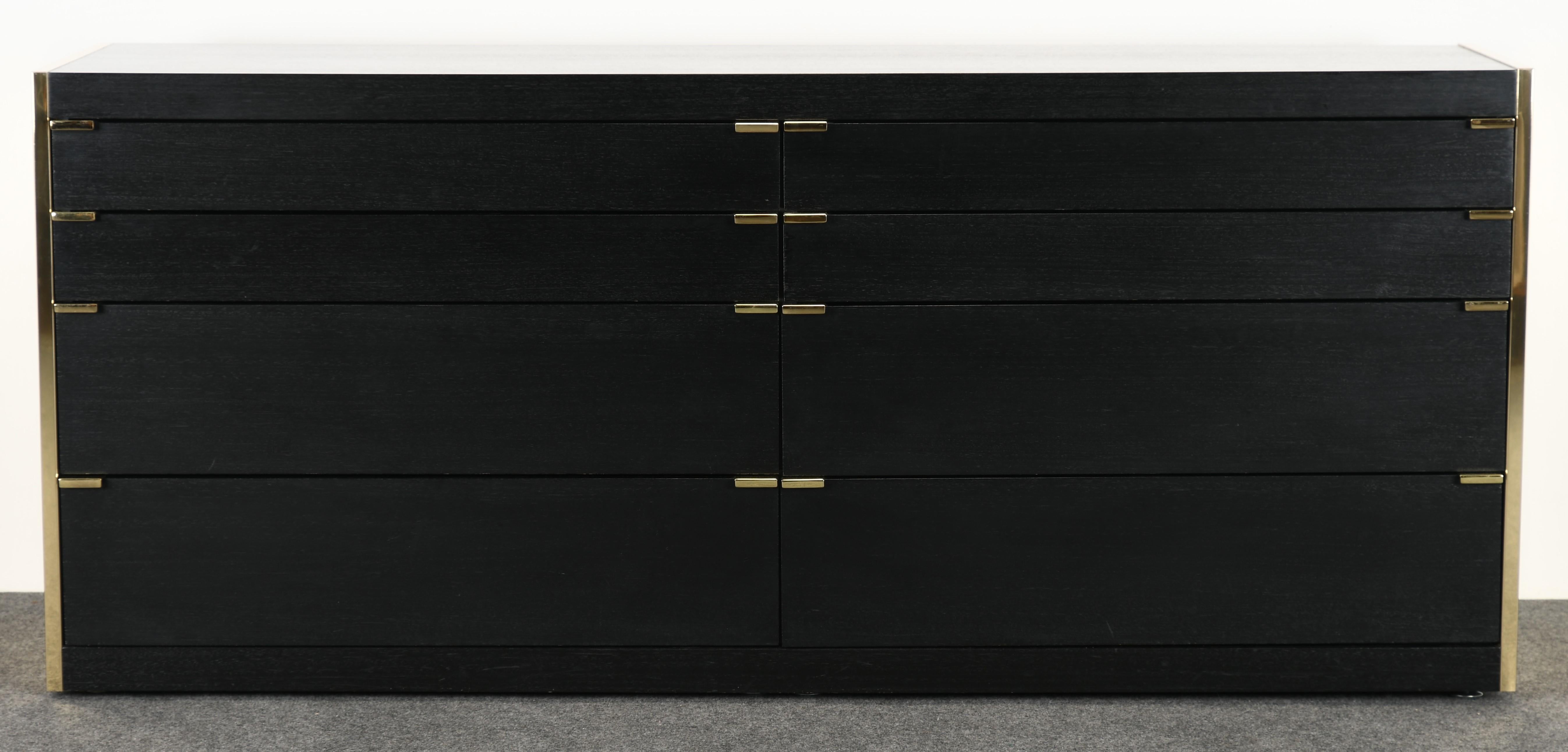 A modern ebonized oak and brass eight-drawer dresser or chest of drawers by Ello Furniture. This beautiful oak dresser is accented with brass sides and brass pulls. Would look great in any traditional or contemporary setting. This chest of drawers