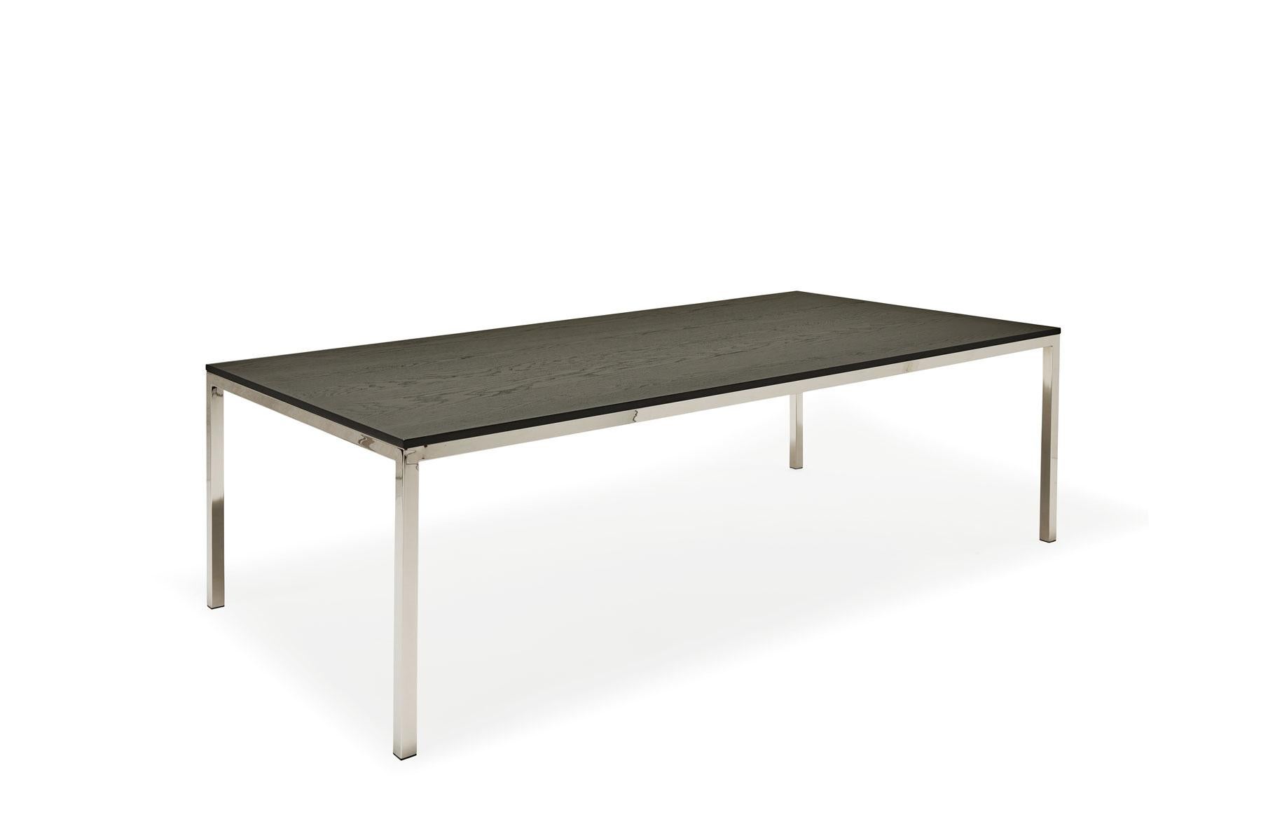 Clean lines and high quality materials are the basis of Stephen Kenn's Inheritance Collection. This simple yet elegant dining table can comfortably seat up to 10 guests, and features a solid ebonized oak tabletop with a polished nickel plated-steel