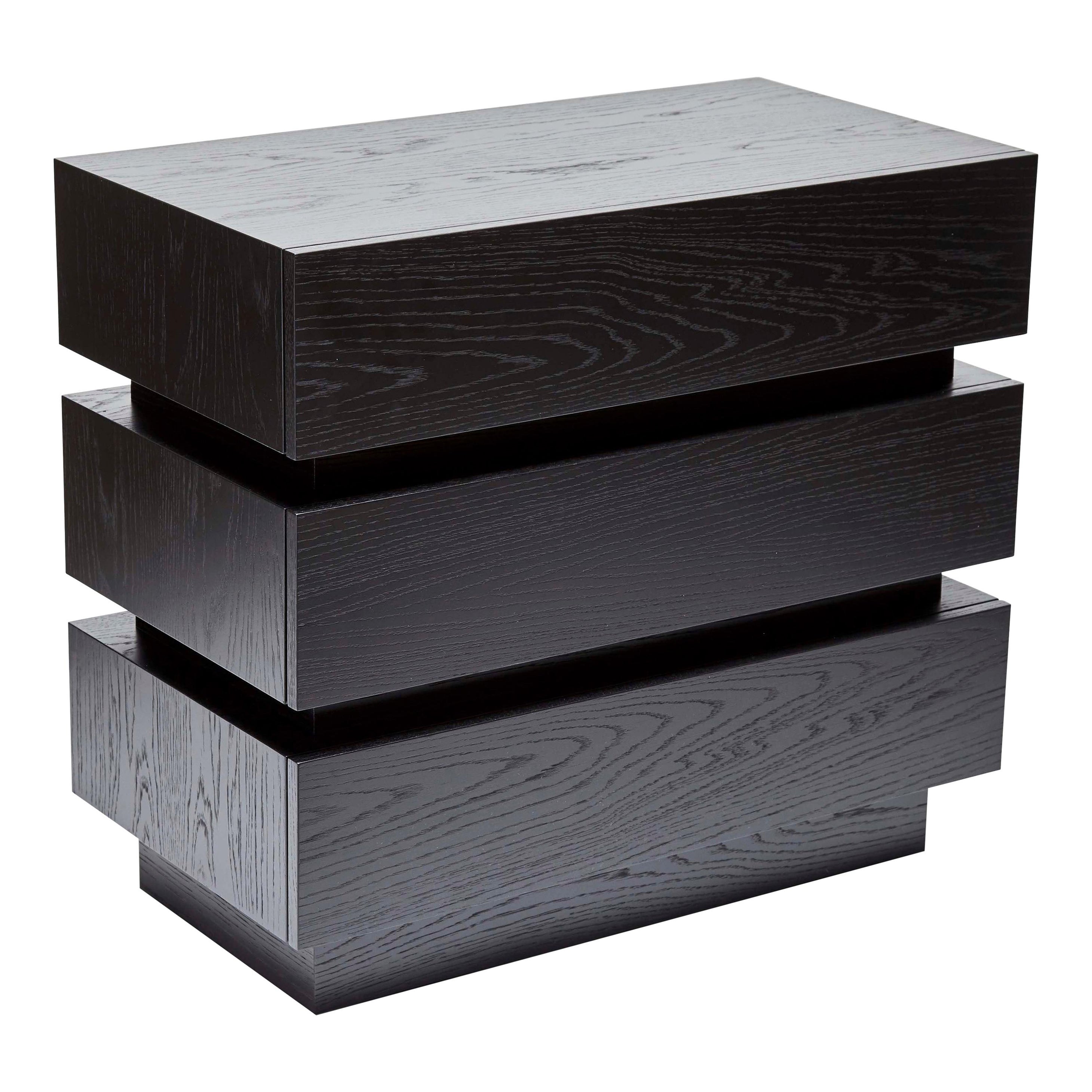 The stacked box chest is a larger modified version of the stacked box nightstand. The piece features three drawers and an inset detail that can be finished with brass plating. Available in American walnut, white oak, or pigmented oak. 

The