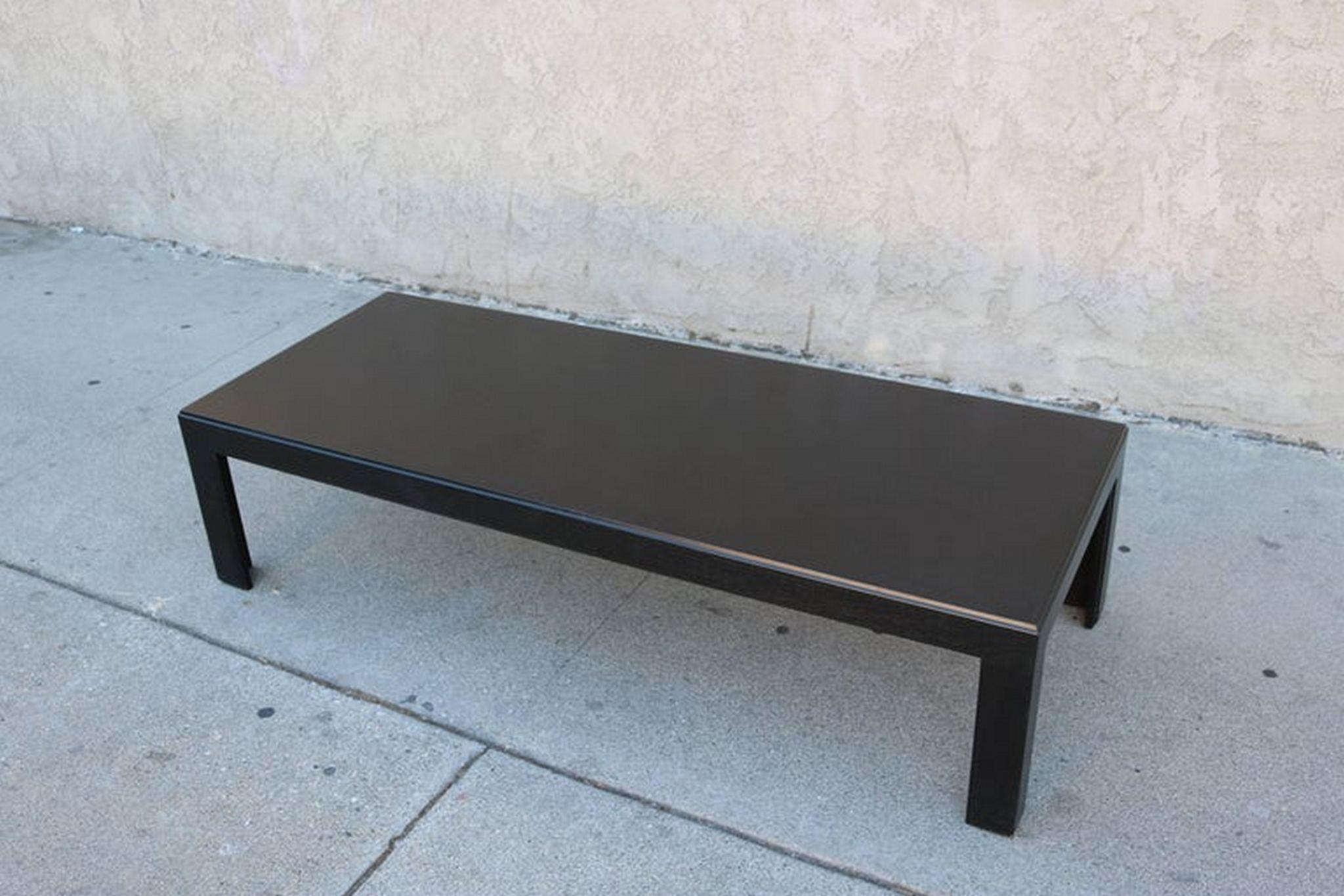This ebonized coffee table features sleek lines and could be in any interiors.