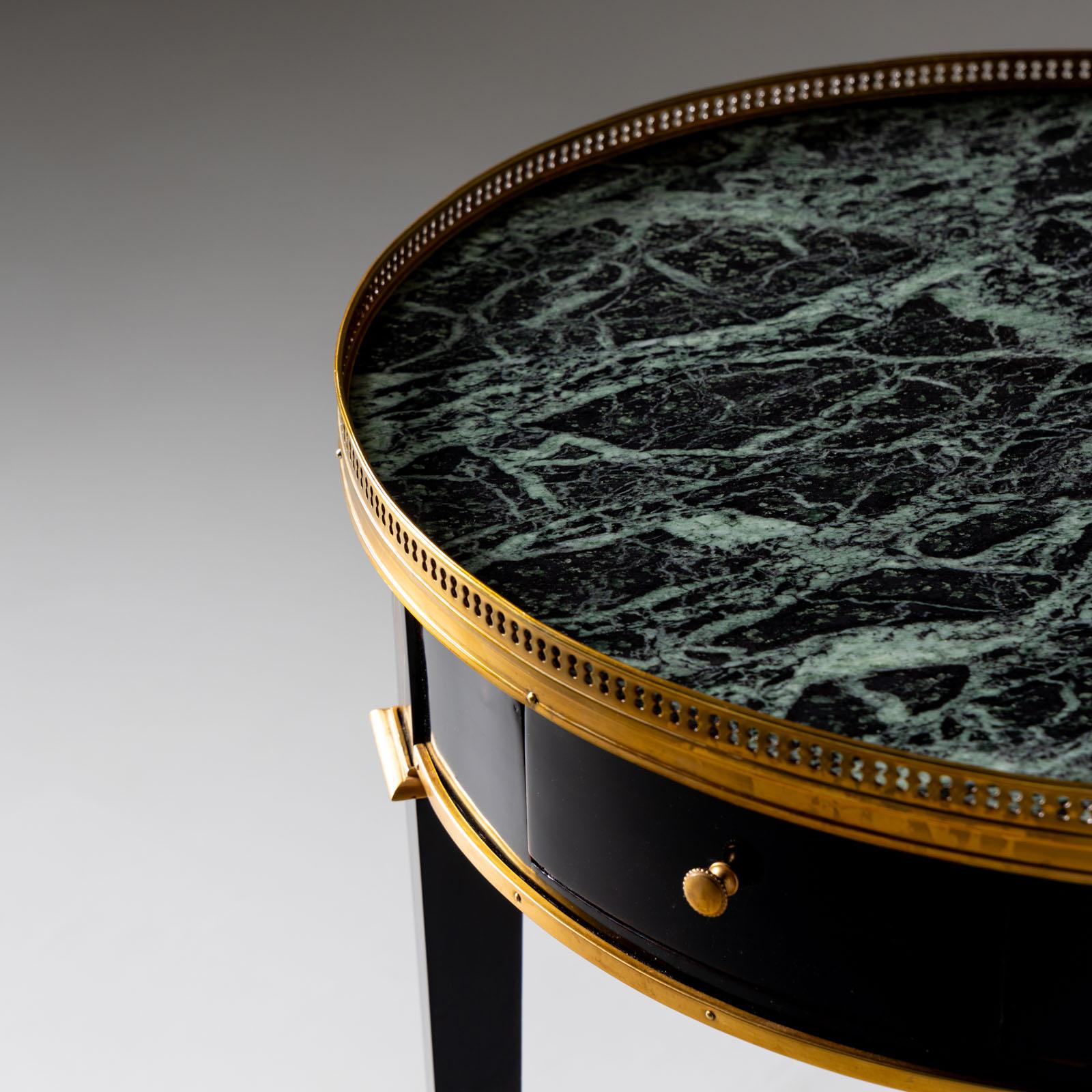 Elegant ebonized side table featuring a brass gallery and a convenient small drawer. Topped with a striking green marble, its smooth frame boasts brass-framed diamonds at leg height, while a brass strip adorns the lower edge. Standing on high