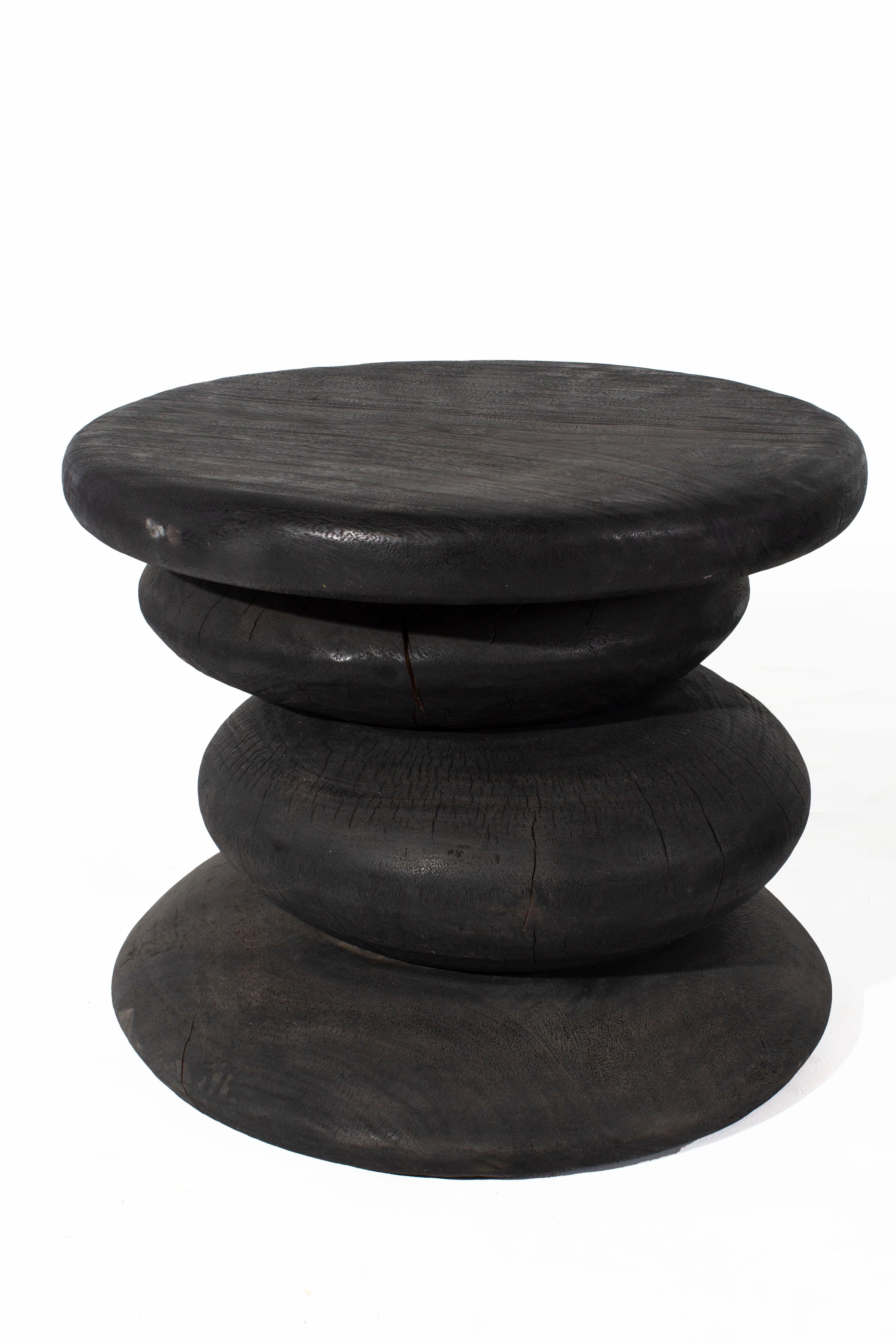Ebonized teak drum style end table with off set circle design.

2 available, both vary in shape and are not identical.