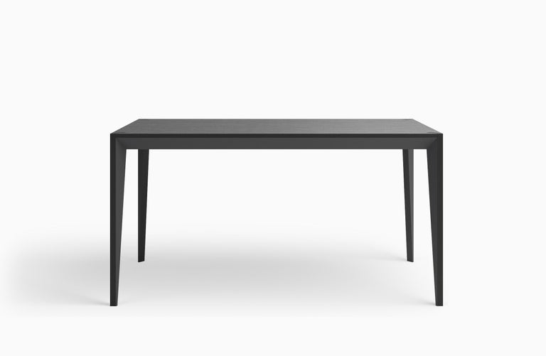 The faceted geometry of the MiMi desk creates a slender, elegant profile and captures light differently depending on the orientation. This modern and graceful design returns contemporary Italian Craft to the office desk or compact dining table for