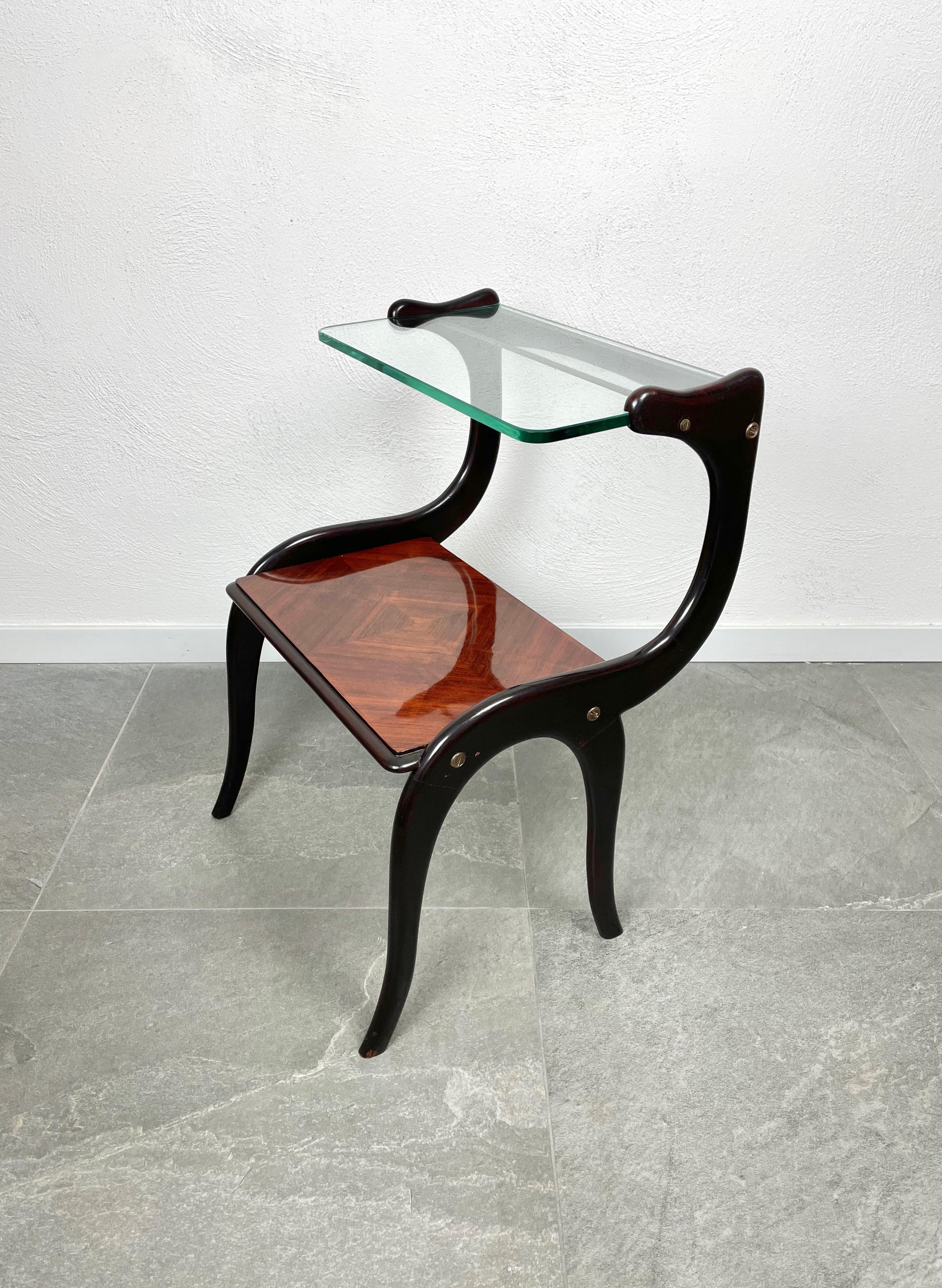 Side end table composed of two shelves, the upper one in glass and the lower in wood, and a structured in ebonized wood. Attributed to Ico Parisi, Italy, circa 1950.