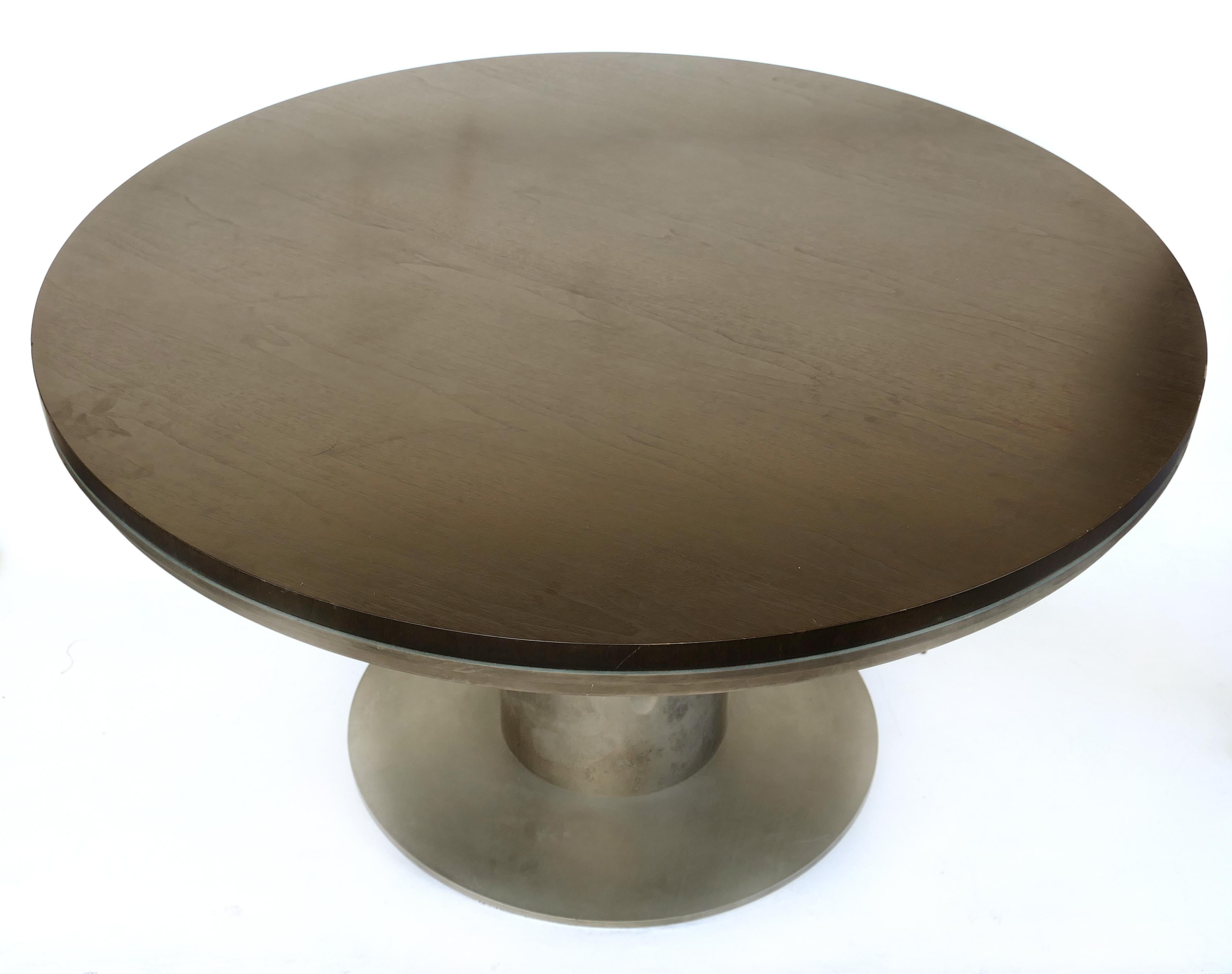 Ebonized wood and steel studio Industrial dining/center table

Offered for sale is an ebonized wood and steel industrial round dining table. This studio creation uses raw industrial materials that still retain the commercial markings on the