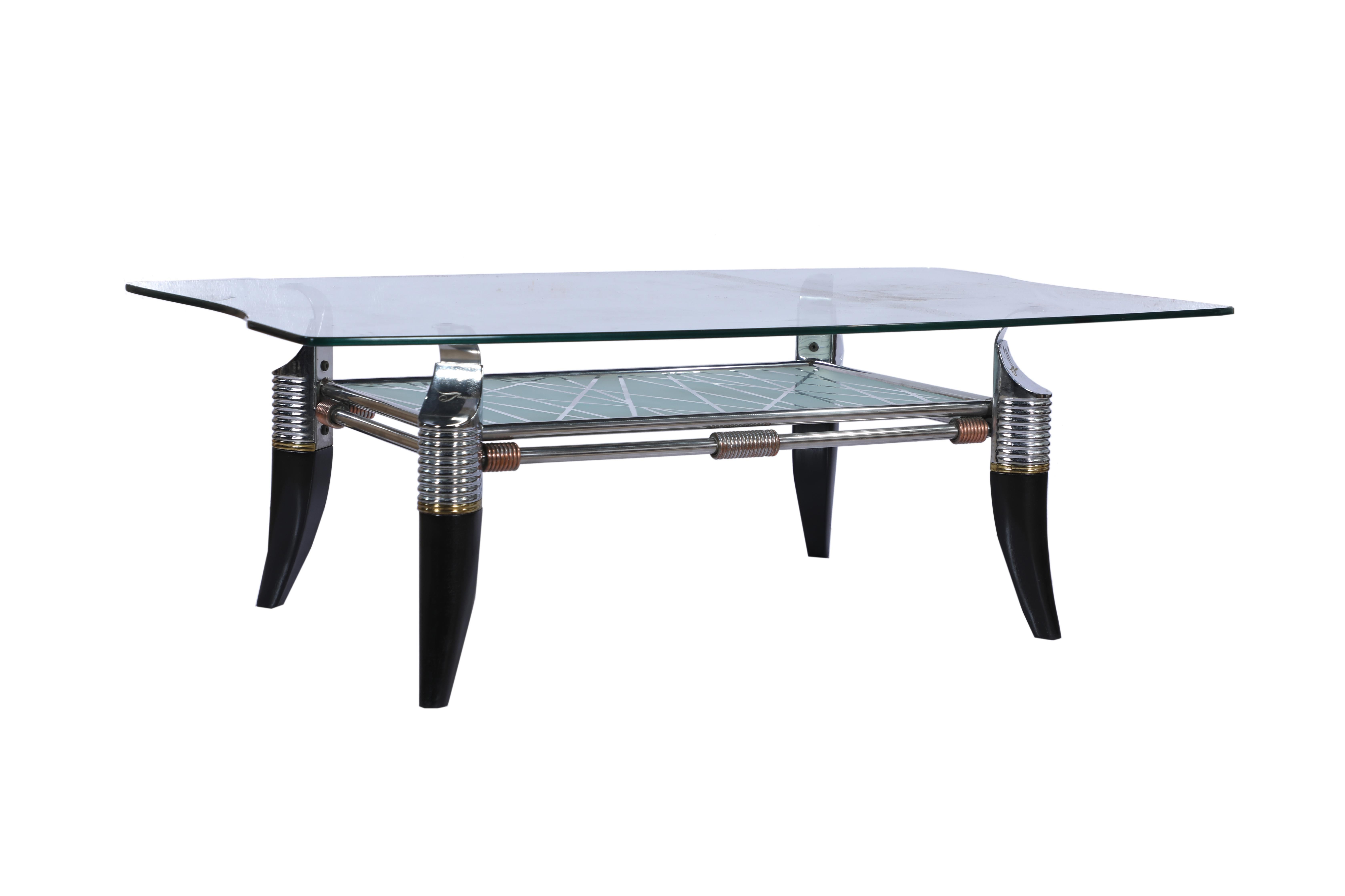 A very unusual Mid-Century Modern coffee table. It features ebonized legs in a faux Horn motif, chrome detailing with a curved glass top and etched glass second shelf. As of this writing, there is a sister piece measuring 27 x 26. Together they
