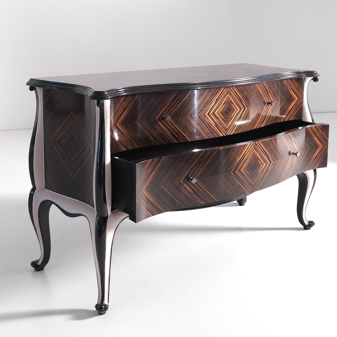 This exquisite dresser echoing clear classic inspiration is distinctive for its soft lines and precious materials. The graceful silhouette in cherry and Makassar ebony boasts the striking natural patterns of the wood's veins harmonizing with the