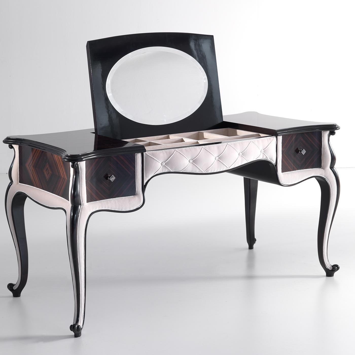The distinctive and intense veining typical of Makassar ebony are showcased in this exquisite vanity table gracefully resting on four cabriole legs. Precious inserts of light leather extensively adorn the design, including the quilted motif in the