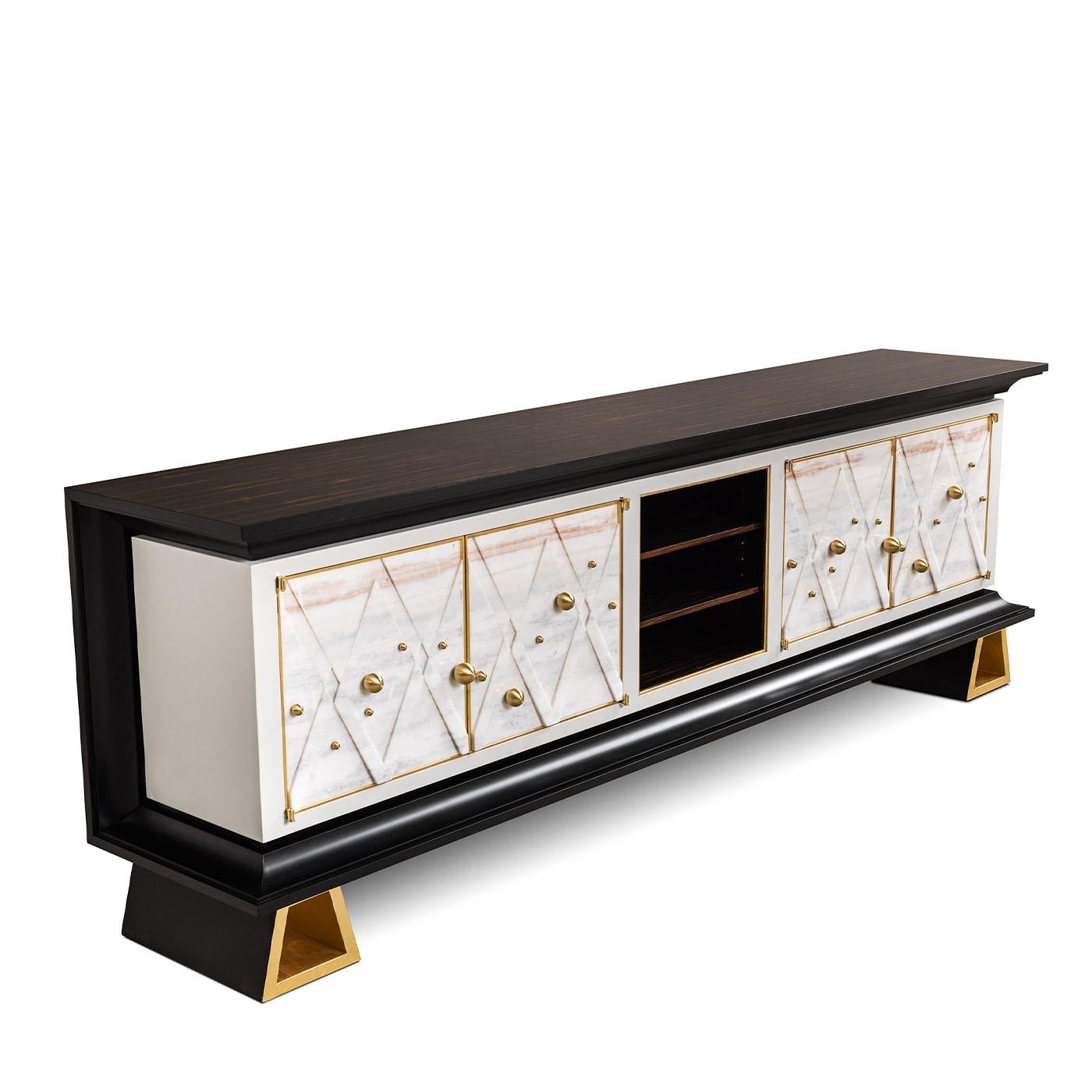 This elegant sideboard is composed of ebony and white lasa marble adorne with exclusive brass ornaments. Handcrafted and enriched with the detail of gold leaf finish feet.