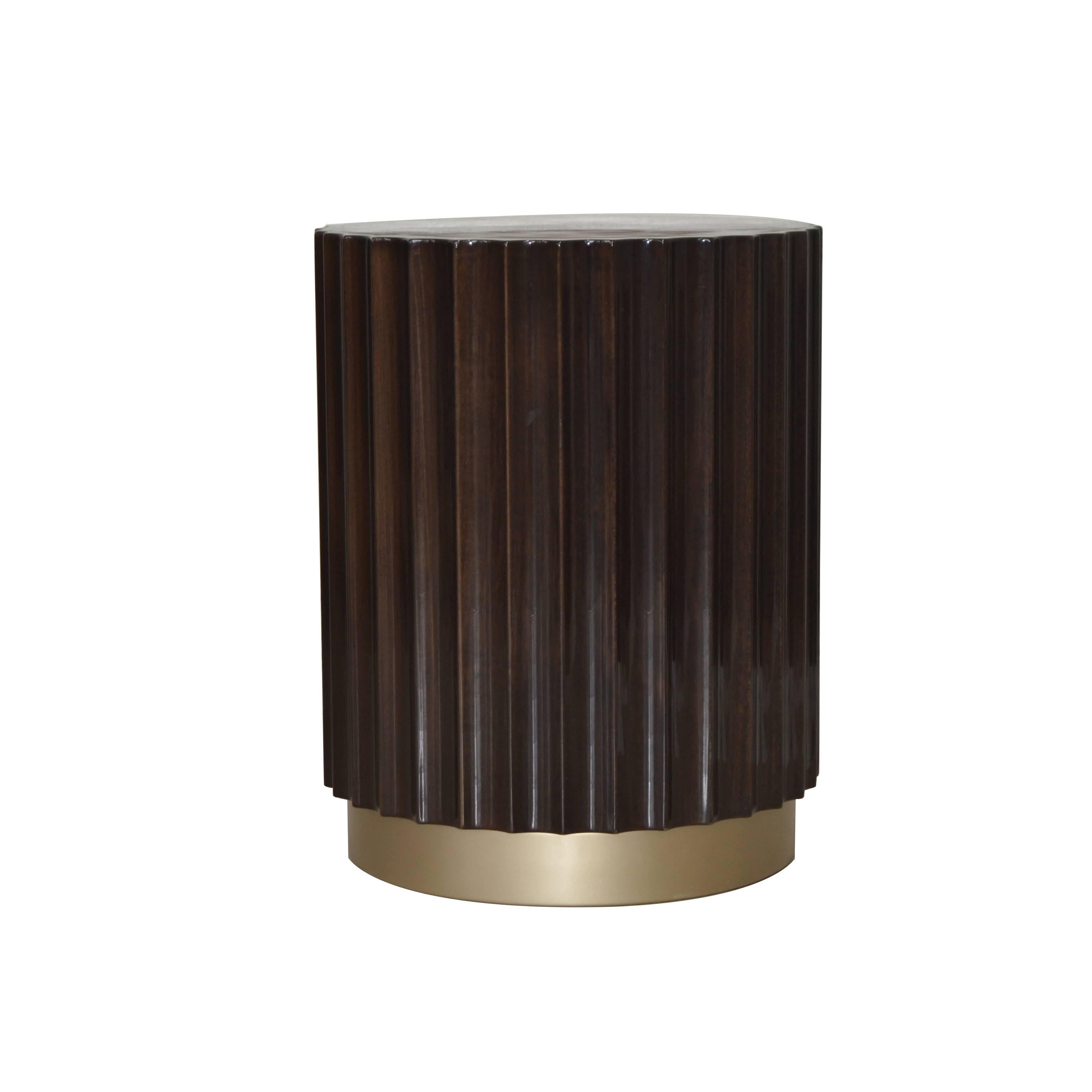 This column pedestal feature ebony brown color with brass painted base. Beautiful glossy lacquer finish, inspired from greek ancient architecture; can also be used as a bedside table.
