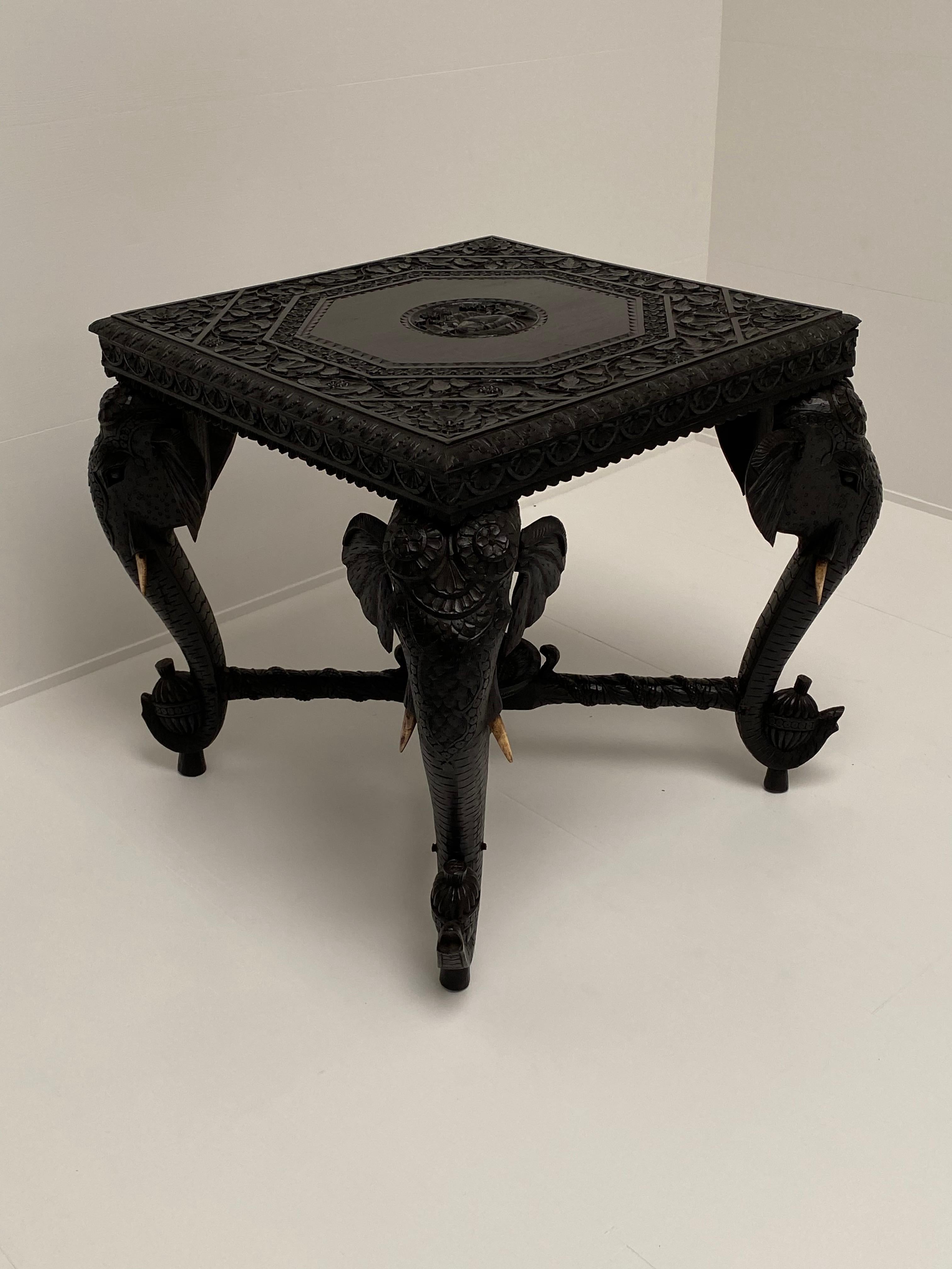 Nice carved ebony dark side table,
beautifully carved elephant heads, nice floral carvings
Asian origin.