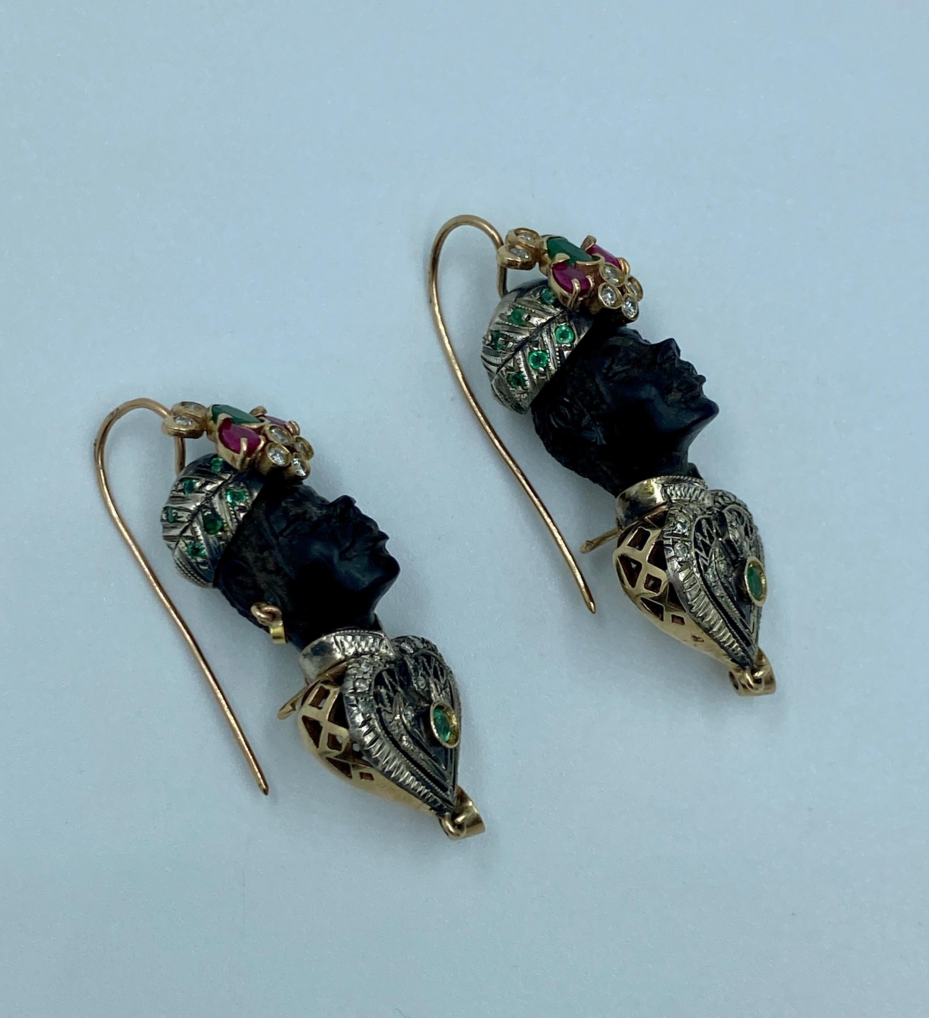 These intricately made moretto earrings are a beautiful example of this style of Moor's heads jewellery. The heads are carved from ebony. The turban and kaftan are made out of silver and adorned with emeralds, rubies and diamonds set in 9k gold.