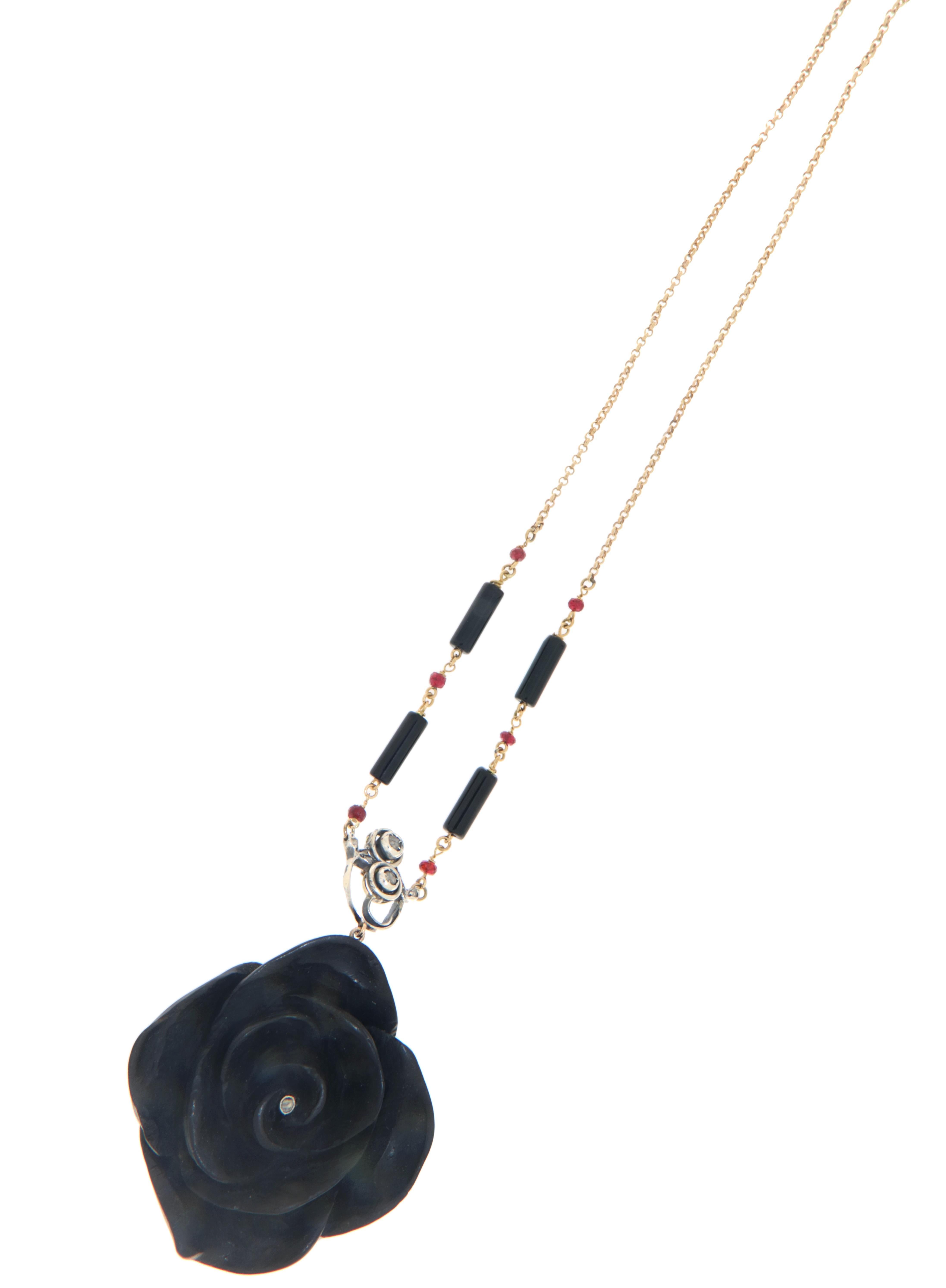 Extraordinary floral pendant, a unique and refined piece crafted in 14-carat yellow gold and 800 thousandths silver, enriched with precious materials and exquisite artisanal details. At the center of this remarkable piece stands a flower carved in