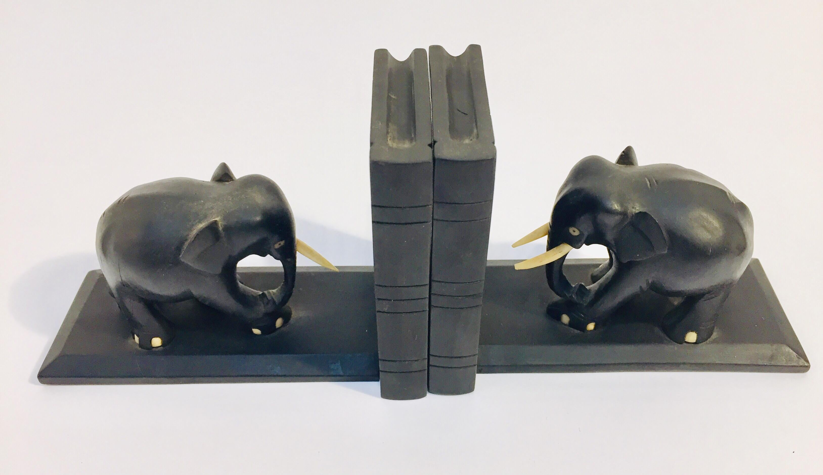 Nice pair of hand carved wooden ebonized elephant bookends.
One of the elephant is missing one tusk.
These are hand carved and therefore not completely identical, 
circa 1950
Handcrafted in Rajasthan, India.
Each book end is: 6