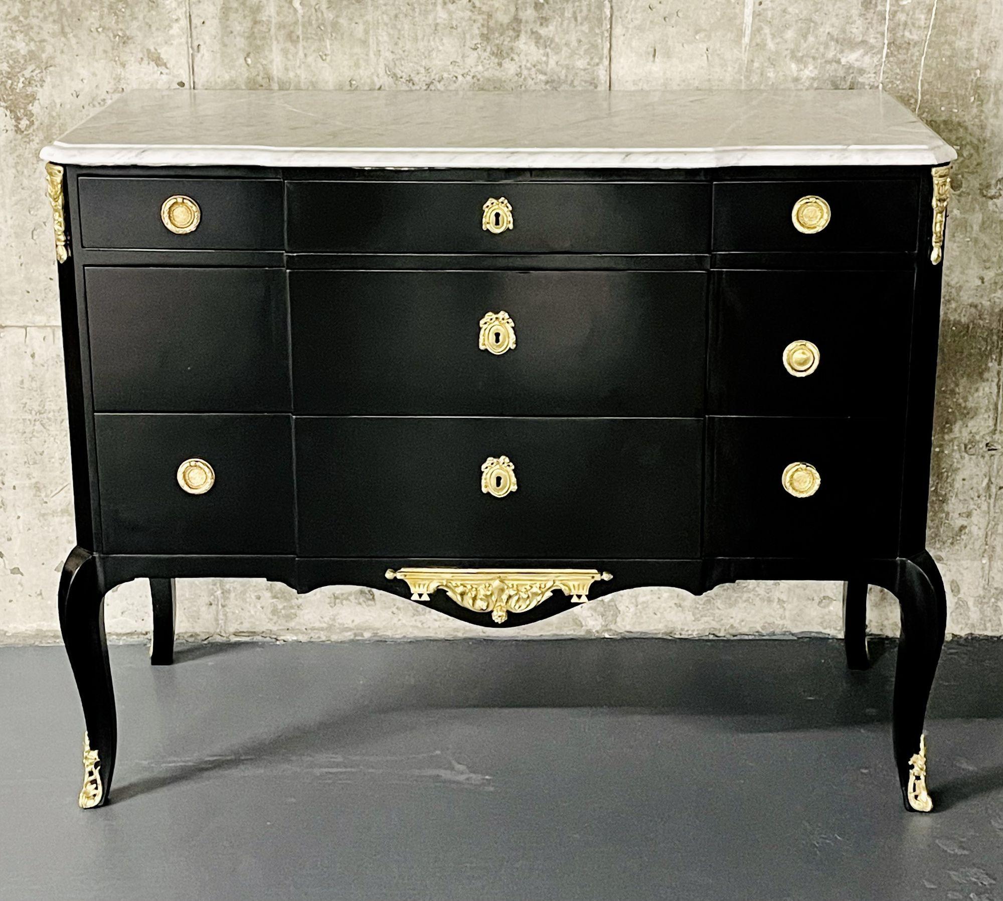 An Ebony Louis XV commode or chest in the Hollywood Regency Fashion.
 
This stunning French chest or commode has three over two drawers in the blockfront form with bronze pulls. The recently refinished chest leaves no stone unturned and is in